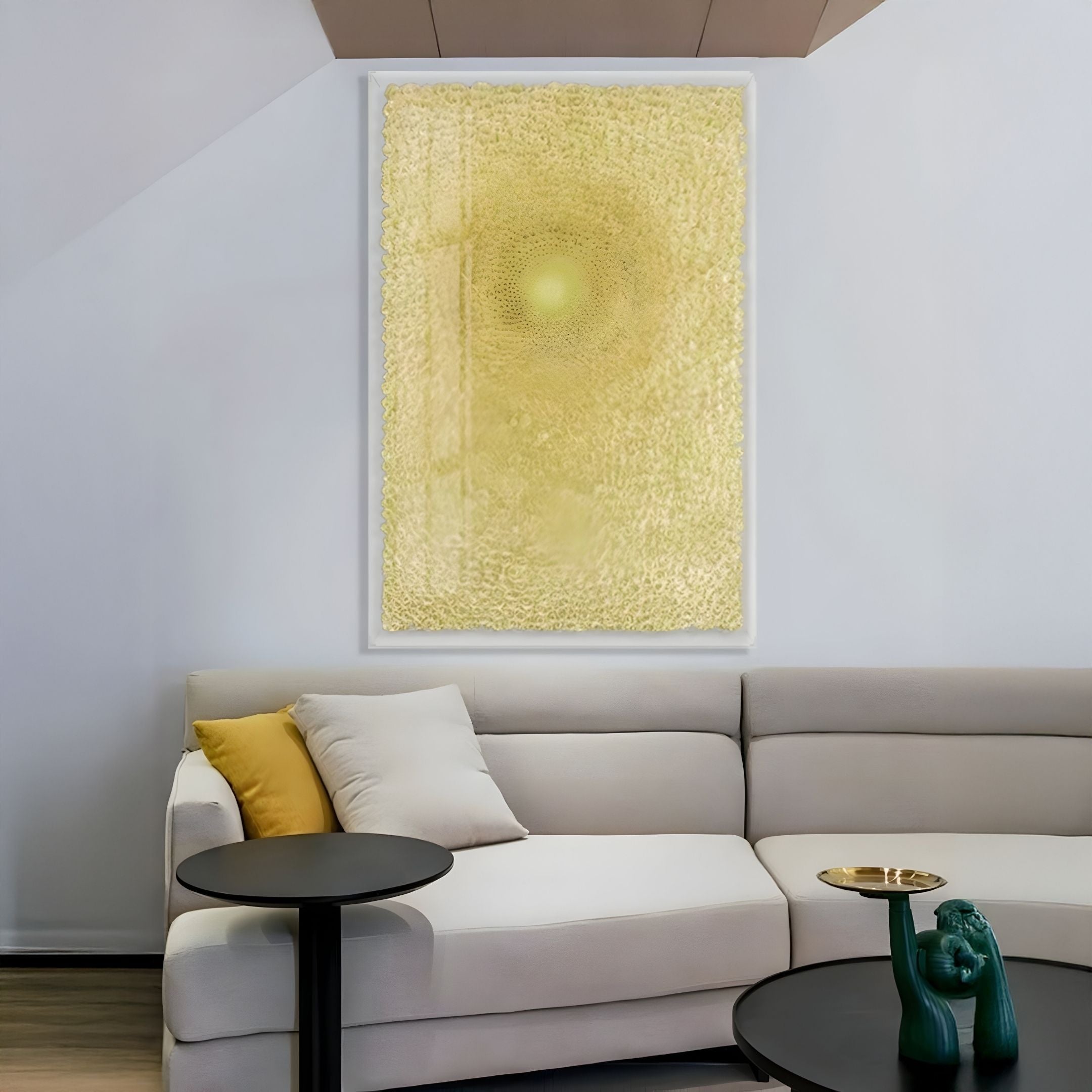 A modern living room with a light beige sectional, yellow and beige cushions, two round black side tables, a green decor piece, and the Giant Sculptures Lumora Sunburst Yellow Acrylic Framed 3D Paper Wall Art adding vibrant texture.