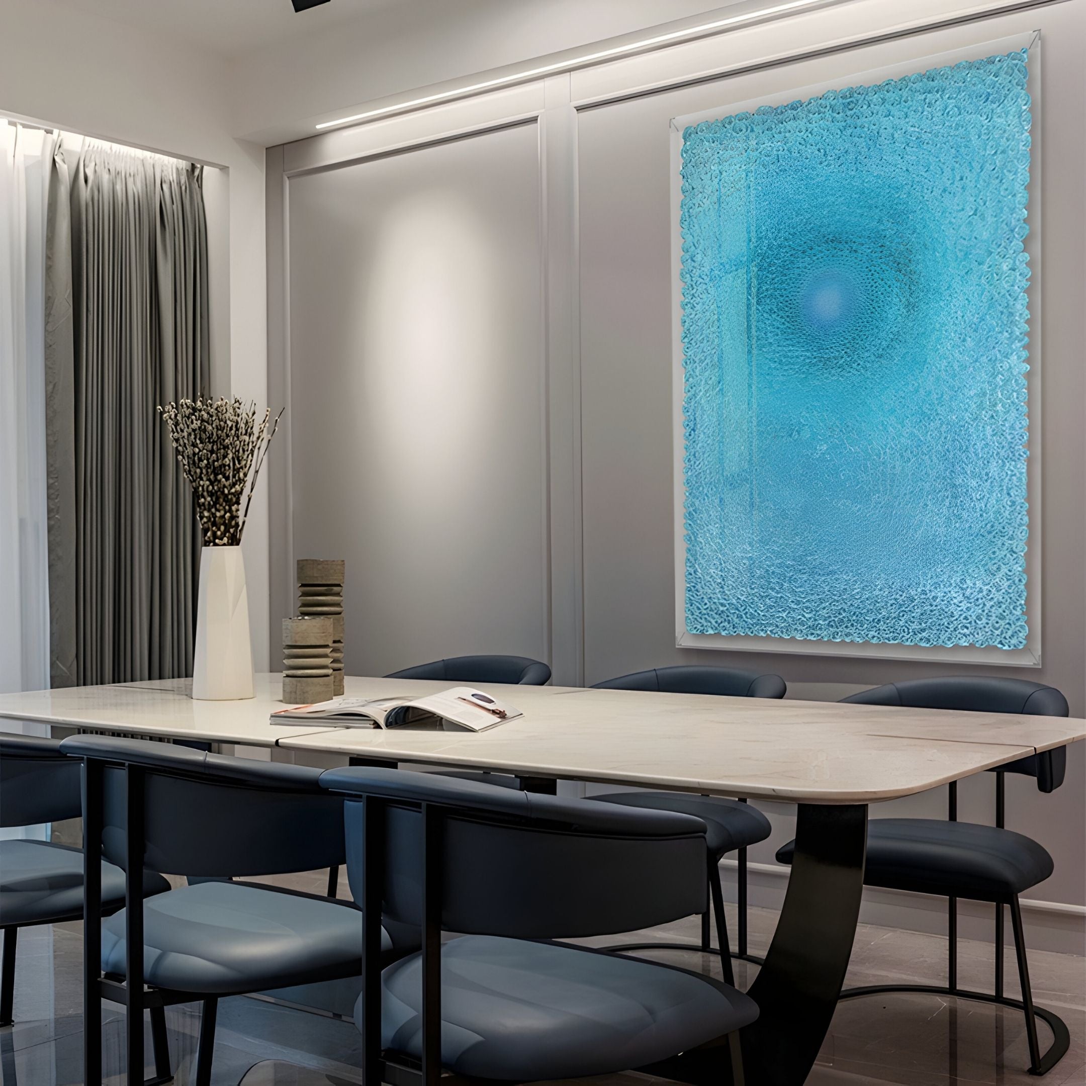 A modern conference room features a long table, dark chairs, a white vase with dried flowers, and the Lumora Aqua Blue Acrylic Framed 3D Paper Wall Art by Giant Sculptures. An open book and stacked items on the table enhance the contemporary vibe.