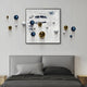 A modern bedroom with a gray bed, gray bedding, and light wood nightstands features Aeroluxe Navy & White Abstract 3D Wall Art With Metal Balls by Giant Sculptures—blue, gold, and white spheres on textured white above the bed and on the wall.