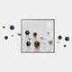 The Aeroluxe White Swirl Abstract 3D Wall Art With Metal Balls by Giant Sculptures features a central square frame with blue, gold, and white spheres and sculpted shapes extending outward, creating a striking modern statement for your wall.