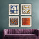 The Stratonis Ember Linear Textured Framed Wall Art by Giant Sculptures, in blue, gold, gray, and orange tones, is arranged in a grid above a purple velvet sofa on a teal wall—ideal for contemporary interiors.
