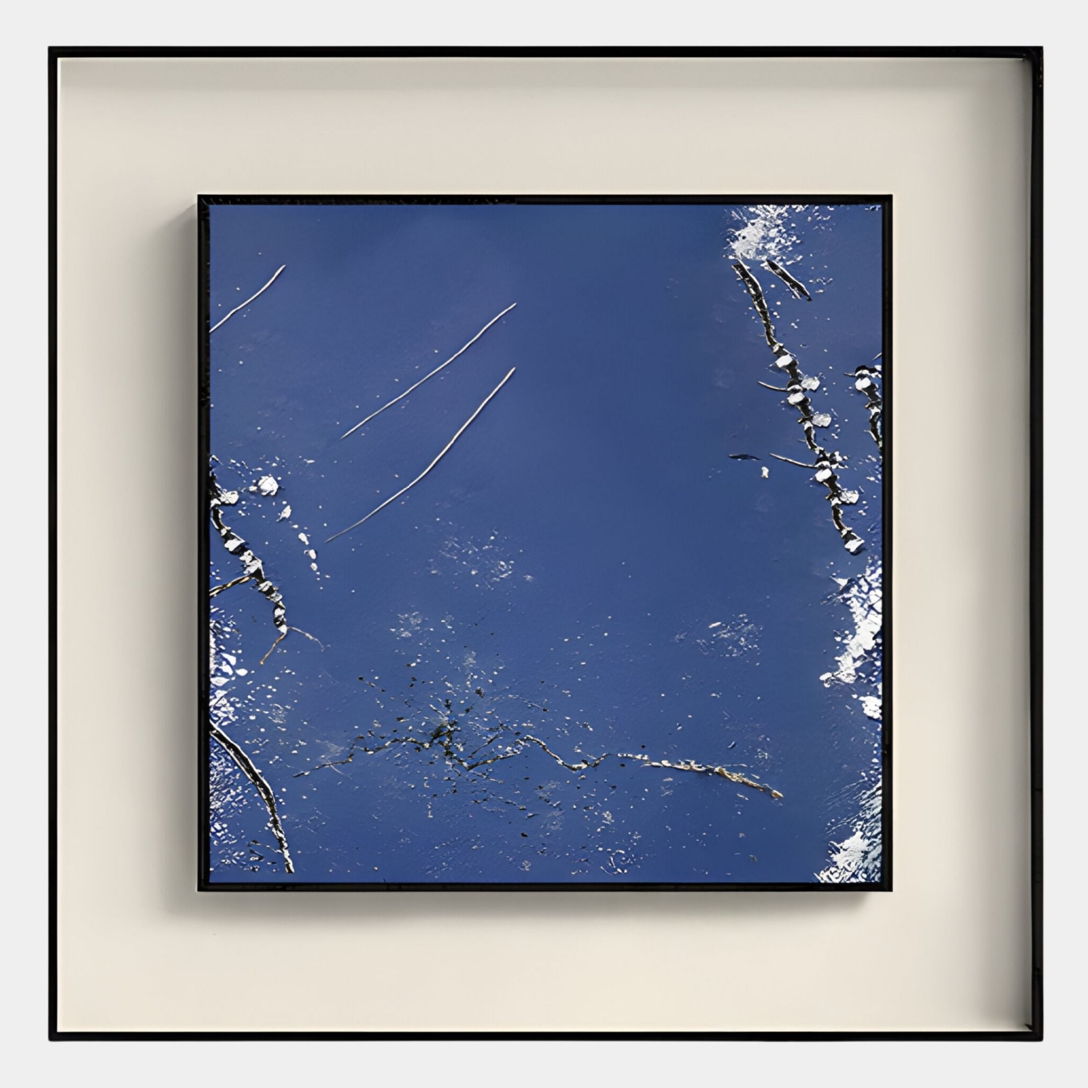 The Trevasse Deep Blue Textured Abstract Framed Wall Art by Giant Sculptures features abstract reflections of tree branches and sky with deep blue tones, white highlights, and a shadowbox frame against a beige background.