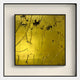 The Trevasse Gold Textured Abstract Framed Wall Art by Giant Sculptures features scratch marks and black lines on a metallic gold background, displayed in a square shadow box frame against a light wall.