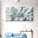 A modern living room showcases the Nivara Ice Blue Ripple Straw 3D Wall Art by Giant Sculptures above a minimalist console, paired with a light blue sofa and contemporary decor for a soft, cloud-like ambiance in white and blue.
