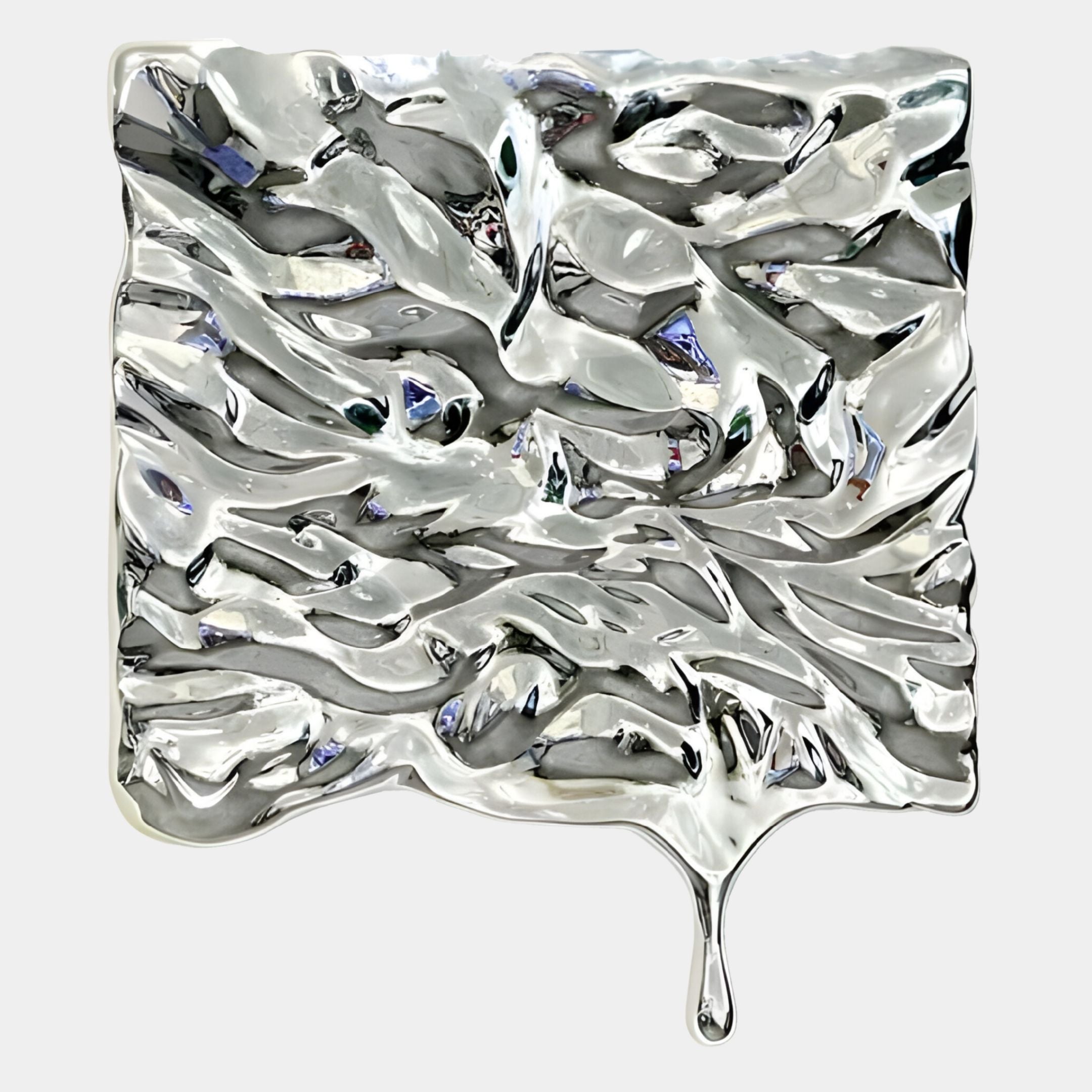 The Lumineris Silver Melted Wave Metal 3D Wall Art by Giant Sculptures features a shiny, wavy, liquid-like texture with an elongated drip and a reflective surface that distorts light for a captivating effect.