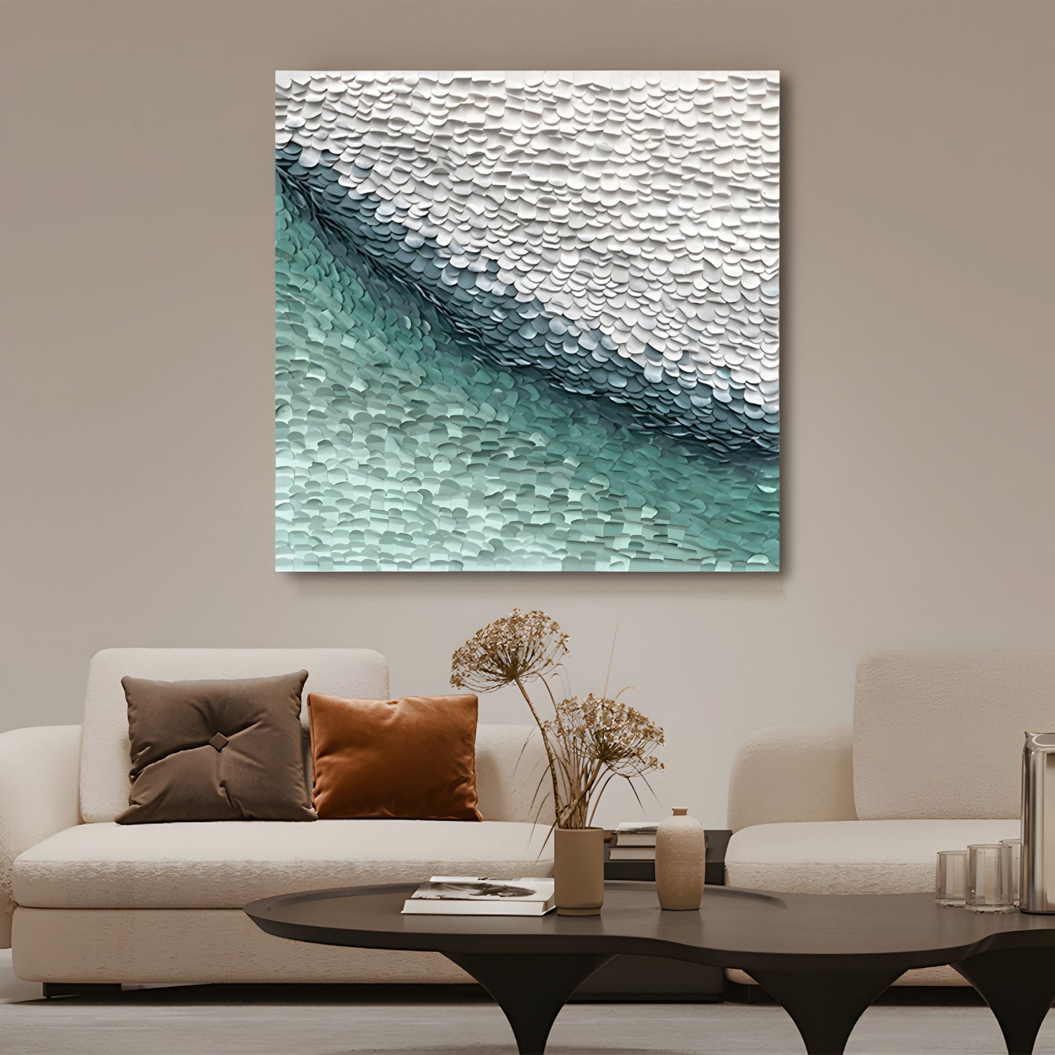 A modern living room with a white sofa, brown and beige pillows, a round black coffee table, and dried flowers in vases features Seravelle Mist Blue Gradient Layered 3D Paper Wall Art by Giant Sculptures above the seating area.