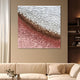 A modern living room with a beige sofa and cushions features Giant Sculptures' Seravelle Rose Gradient Layered 3D Paper Wall Art, showcasing textured pink, brown, and white hues that resemble layered paper and evoke a rose gradient.