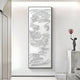 The bright, minimal space features the Auravolta VI Pearl Beads Swirl Pattern 3D Wall Art by Giant Sculptures on a white wall and a modern sculpture of a figure with a pink balloon on white marble steps.