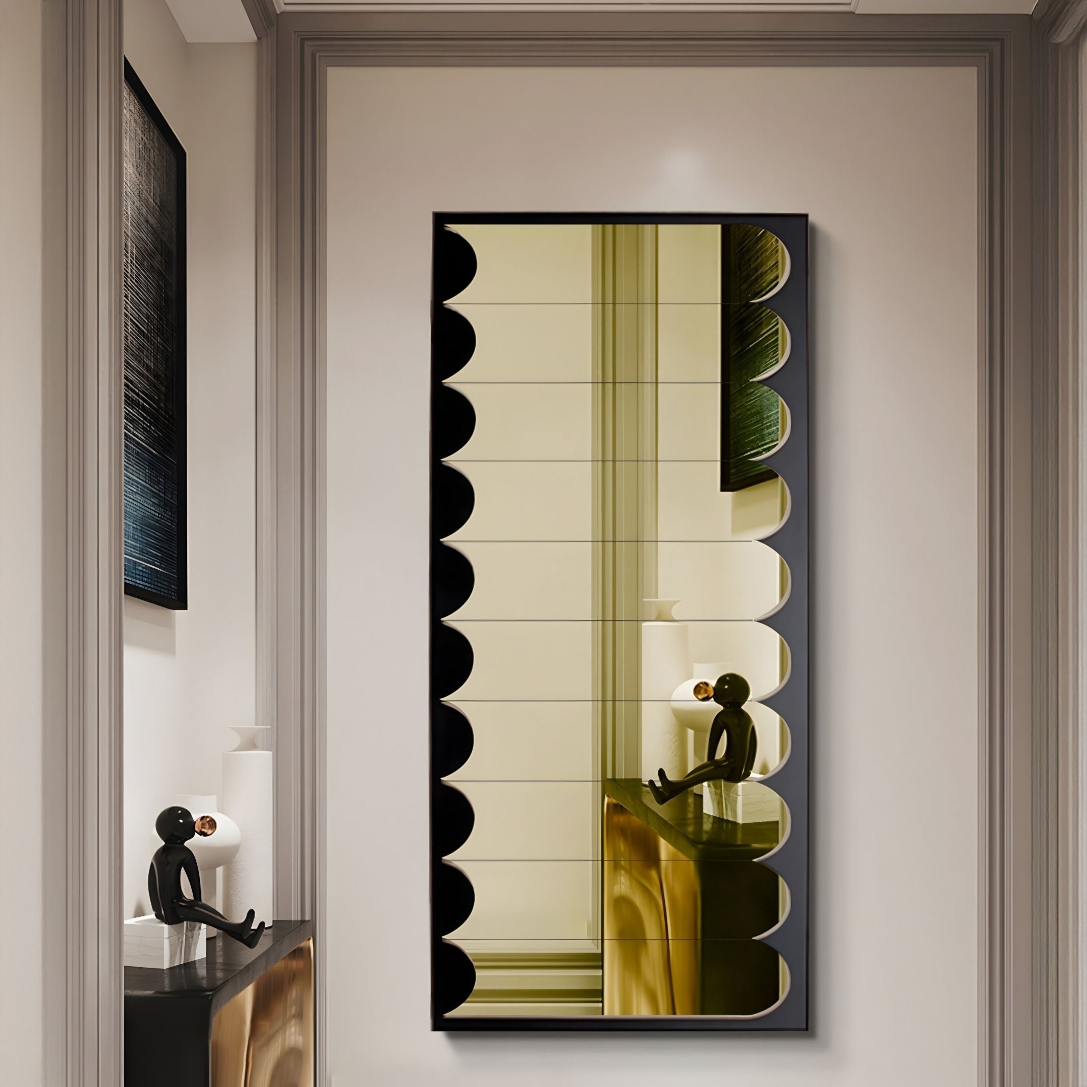The Lumiscale Black & Soft Yellow Modular Glass Wall Mirror by Giant Sculptures reflects a black abstract figurine holding a gold sphere, seated on a cabinet in a modern, neutral-toned hallway with framed art.