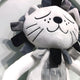 A close-up of the Cuddiloft Grey Lion Plush Display 3D Wall Art by Giant Sculptures, featuring a white face, closed eyes, stitched whiskers, and a gray and black mane—perfect for kids room decor.