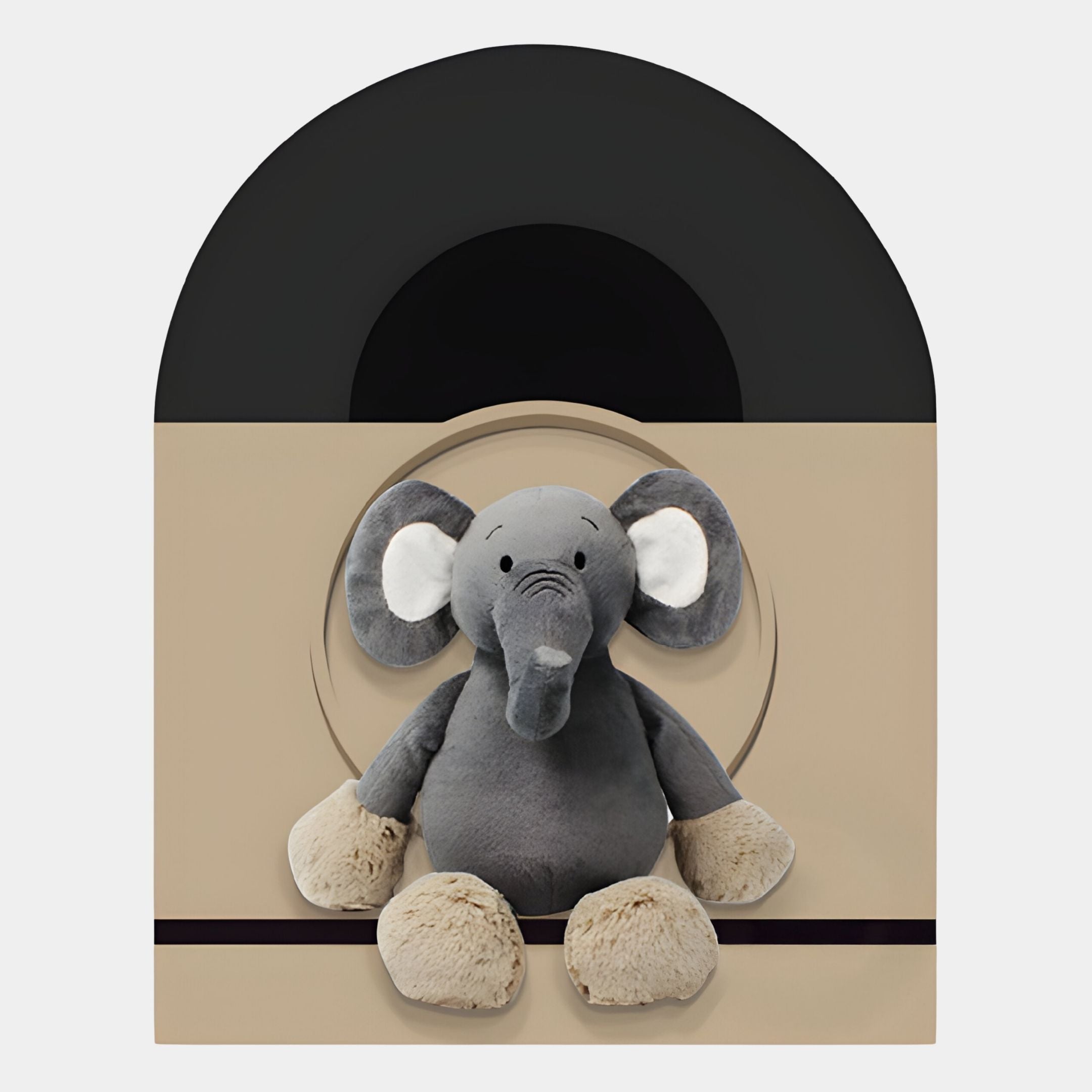 The Giant Sculptures Cuddiloft Elephant Plush Display 3D Wall Art features a gray plush elephant with beige accents seated before a beige and black geometric backdrop—an ideal centerpiece for children’s room decor.