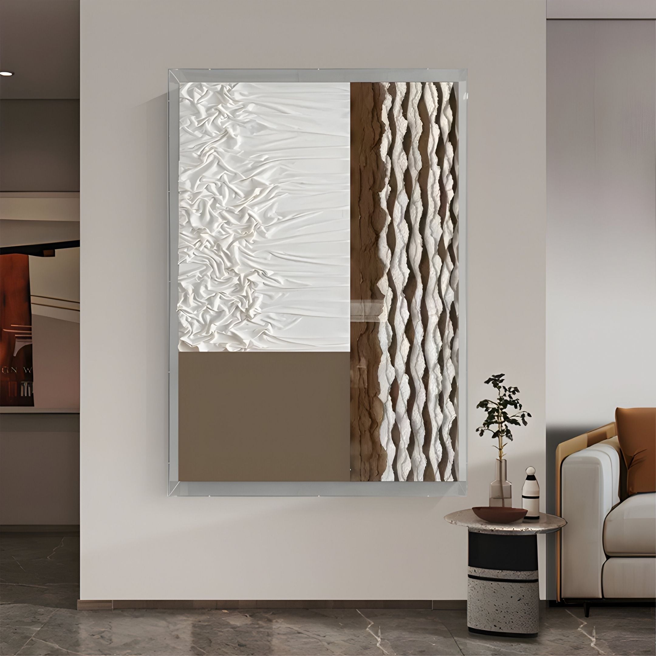 Giant Sculptures’ Texturien White & Taupe Paper Abstract 3D Wall Art features four sections—wrinkled white, smooth taupe, and wavy taupe and white—displayed above a small table and plant next to a beige sofa.