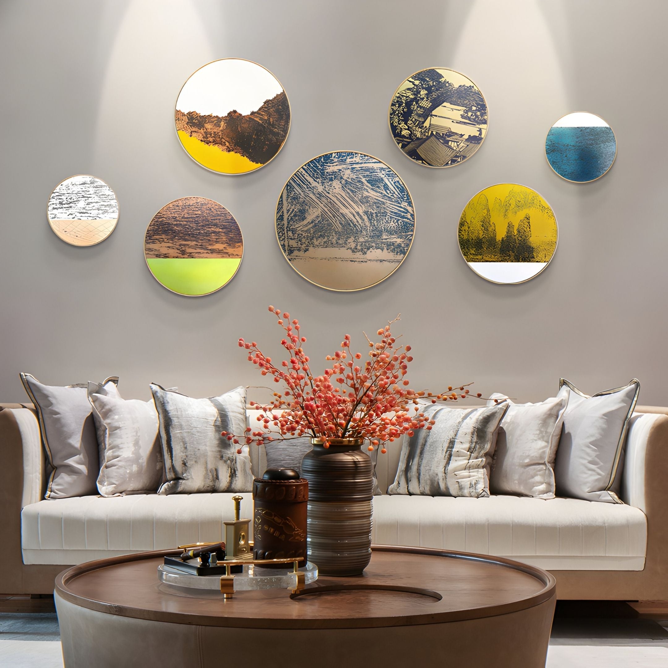 A modern living room with a beige sofa, patterned cushions, a round wooden coffee table, a vase of pink flowers, and the Auralune Copper & Lime Glow Abstract Round 3D Wall Art by Giant Sculptures arranged above the sofa against a light wall.