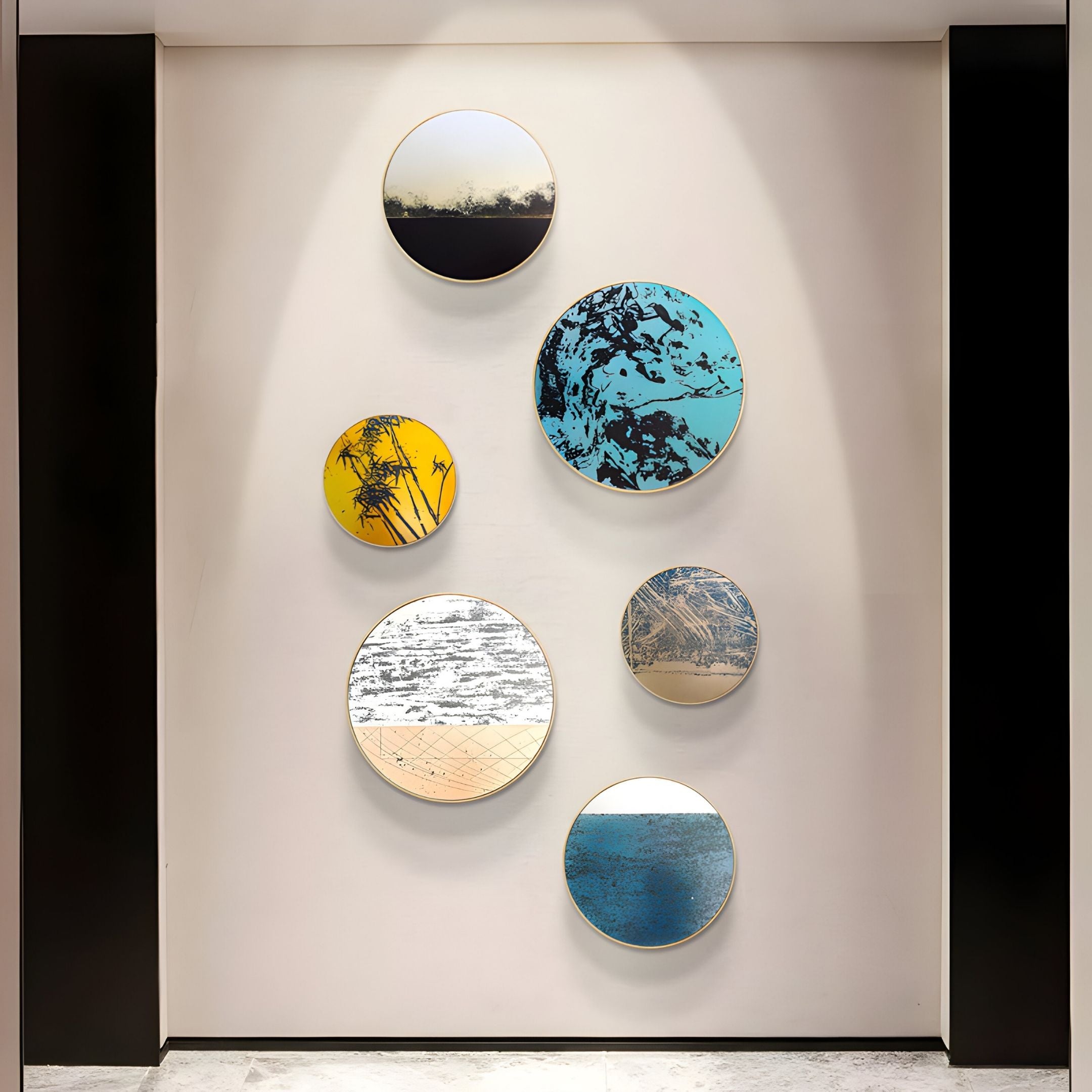 Six Auralune Blush Meridian Abstract Round 3D Wall Art pieces by Giant Sculptures are vertically arranged on a white wall between two black panels, creating a bold and modern display with colorful, abstract patterns.