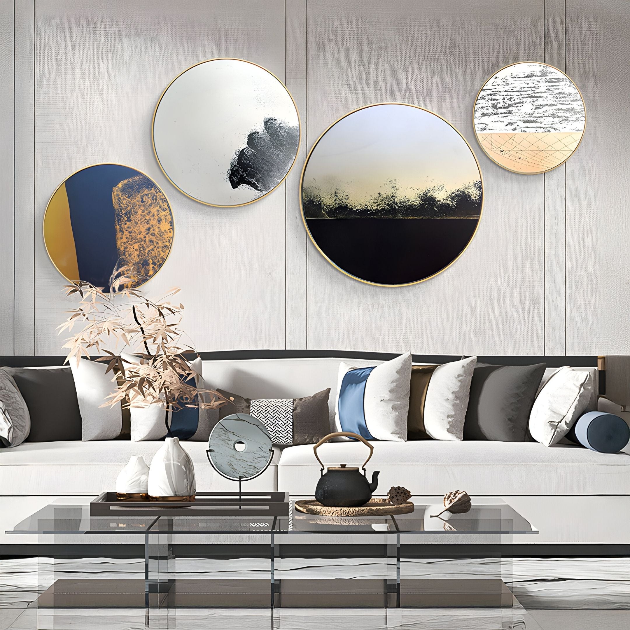 A modern living room features a white sofa with neutral pillows, a glass coffee table with tea set, and four Auralune Midnight Crest & Gold Matrix Round 3D Wall Art by Giant Sculptures above the couch for bold graphic contrast.