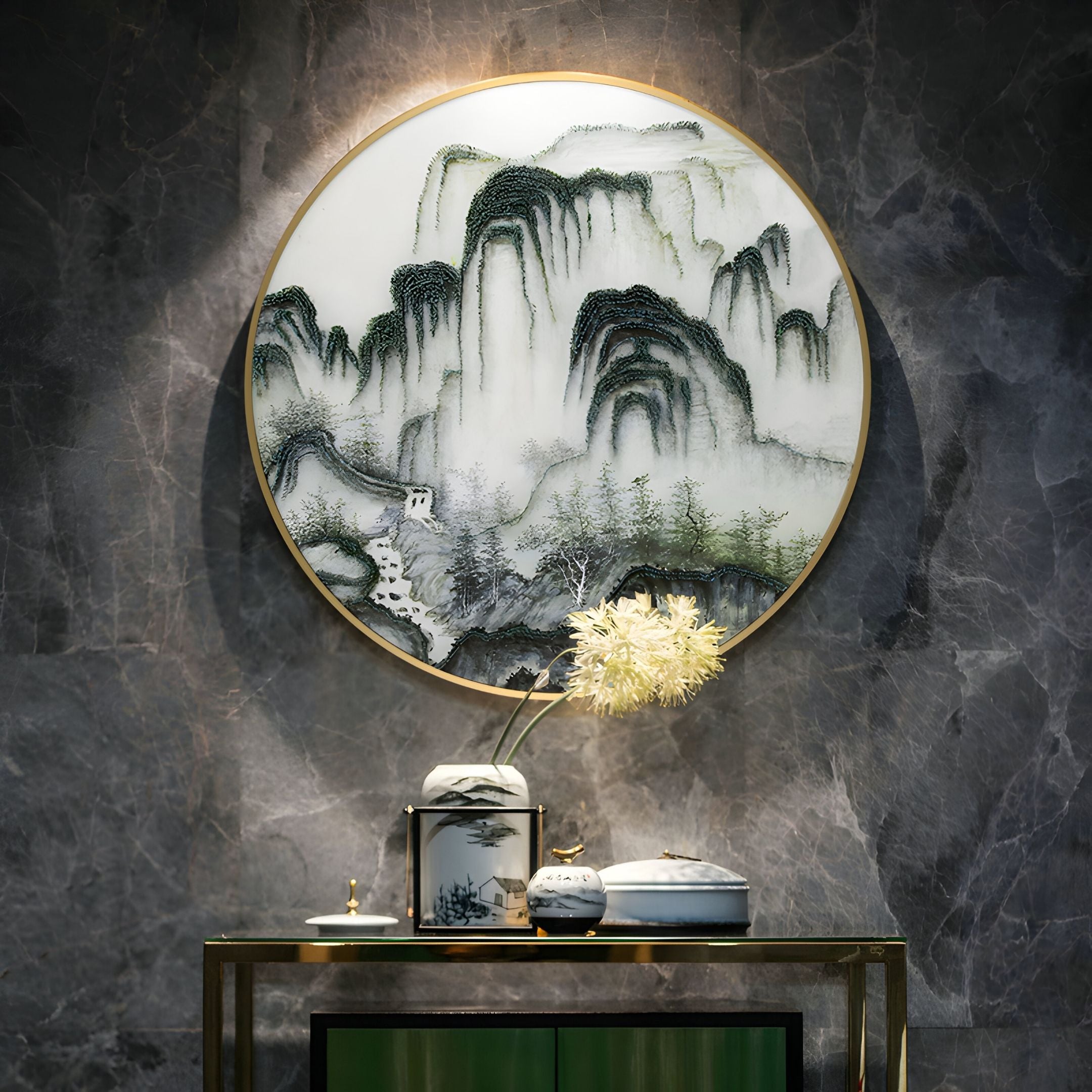 The Montrevian Misty Mountain Cascade Nail Round 3D Wall Art by Giant Sculptures hangs on a dark marble wall above a small table with decorative porcelain jars and a vase of white flowers.