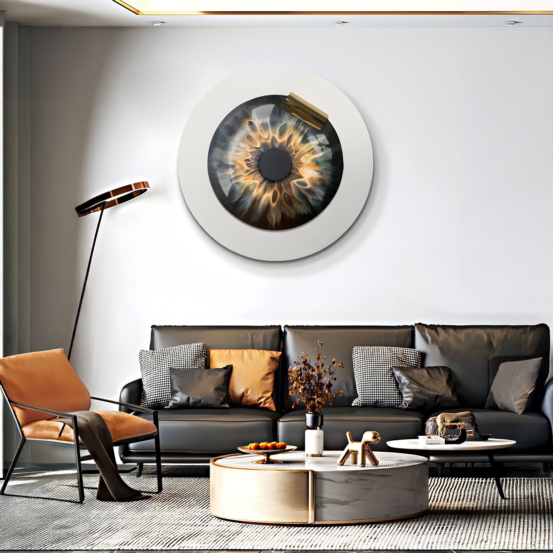 A modern living room features a black leather sofa, orange accent chair, round coffee table, and Giant Sculptures’ Iriselle Amber Flare Crystal Porcelain Round 3D Wall Art above the sofa. A standing lamp angles over the seating area.