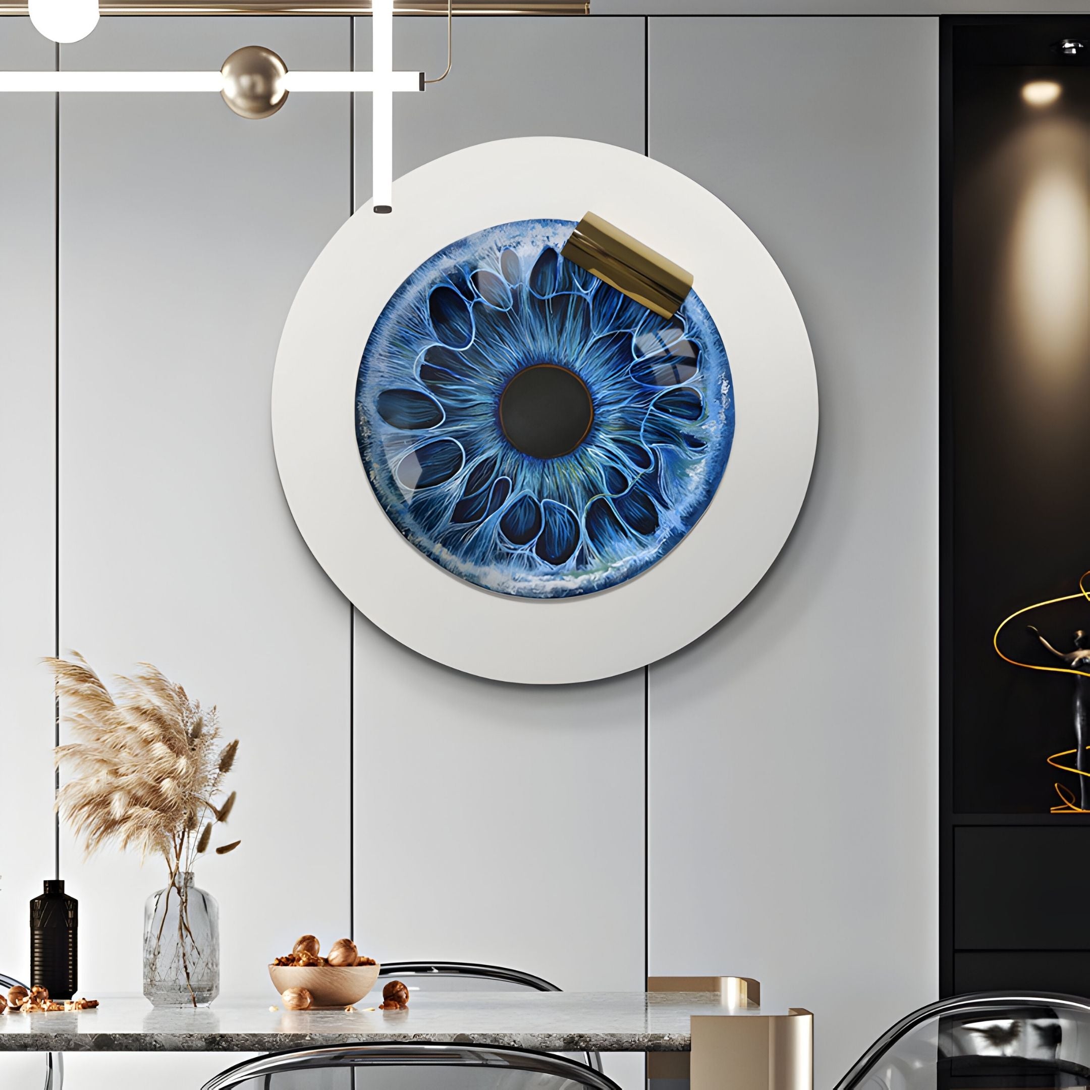 A modern dining room showcases the Iriselle Oceanic Halo Crystal Porcelain Round 3D Wall Art by Giant Sculptures, featuring blue iris-inspired abstract details. Sleek furniture, pampas grass in a vase, and a contemporary light fixture complete the look.