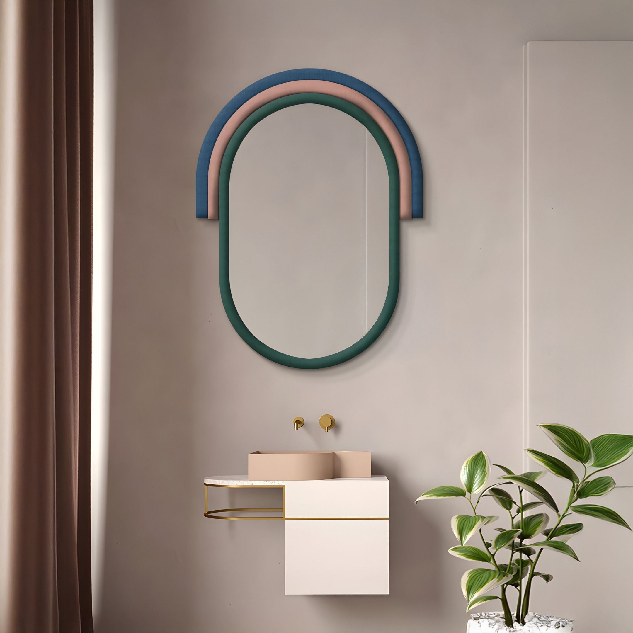 A modern bathroom features the Arcaluna Blue & Blush Layered Arch Mirror 3D Wall Art by Giant Sculptures, a minimalist white sink with gold fixtures, a green potted plant on the right, and brown curtains on the left.