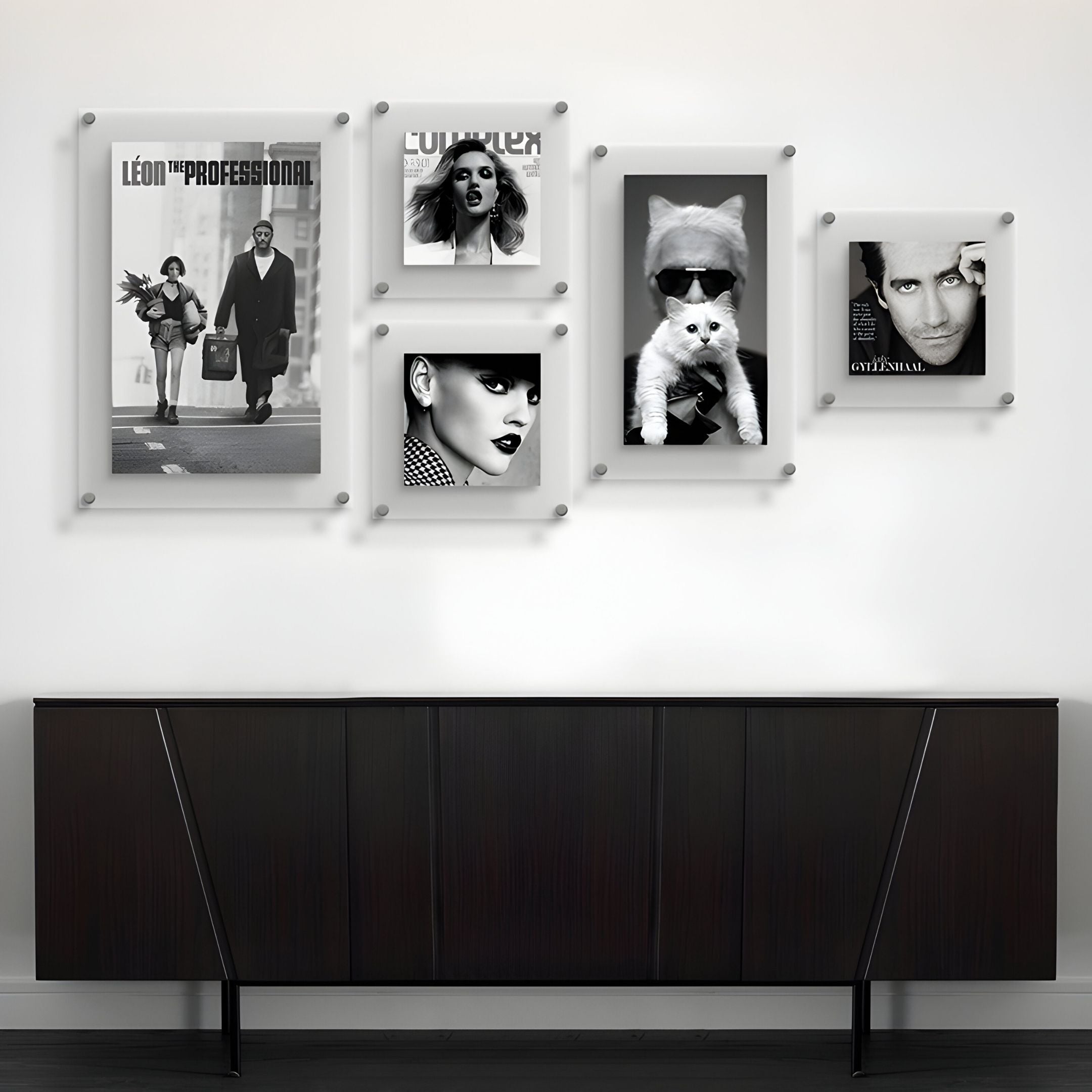 The CineLuxe Fashion Icons Retro 5-Panel Acrylic Wall Art by Giant Sculptures features evenly spaced black-and-white portraits, including fashion icons and a cat with sunglasses, arranged in a stylish grid above a modern sideboard.