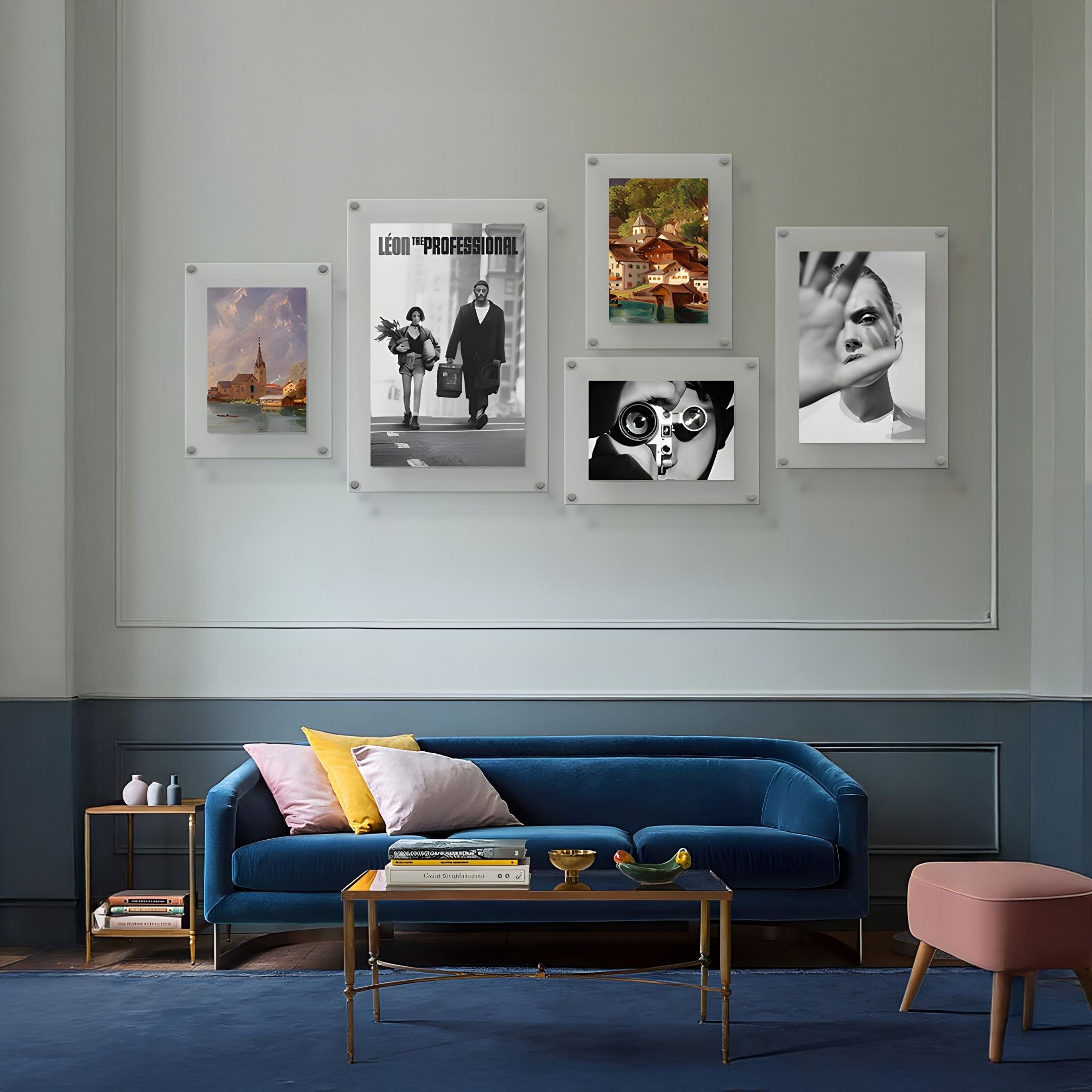 A modern living room with a blue velvet sofa, yellow and gray pillows, a glass coffee table, and the CineLuxe Cinematic Portrait 5-Panel Acrylic Wall Art by Giant Sculptures—ideal for fans of stylish modern interiors.