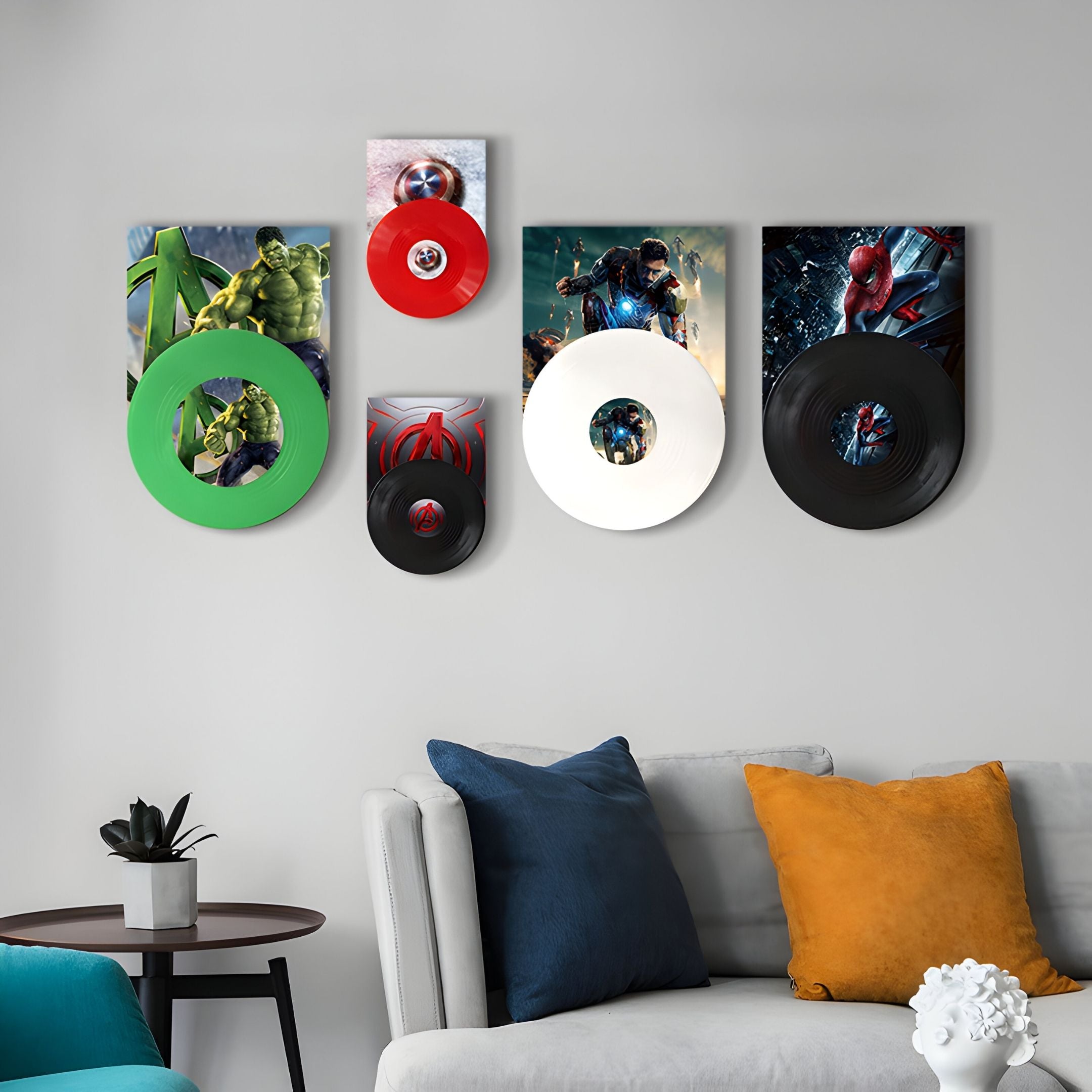 The ReelRiot Comic Legends Record 5-Panel Wall Art by Giant Sculptures adds striking superhero flair above a modern sofa with blue, gray, and mustard pillows, while a side table with a plant completes the comic-inspired look.