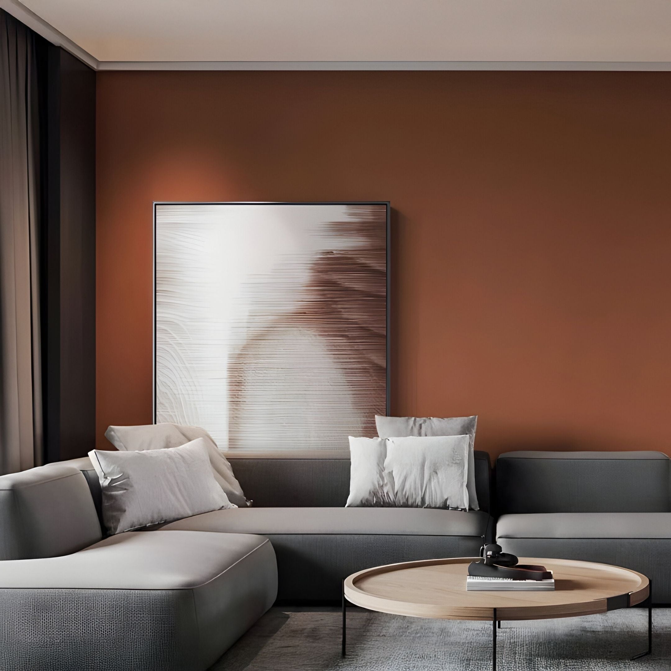 A modern living room features a gray sectional sofa, white and gray pillows, a round wooden coffee table, and the Striathen Sand & Beige Blur Textured Rope 3D Wall Art by Giant Sculptures on a terracotta wall. Natural light streams through dark-curtained windows.