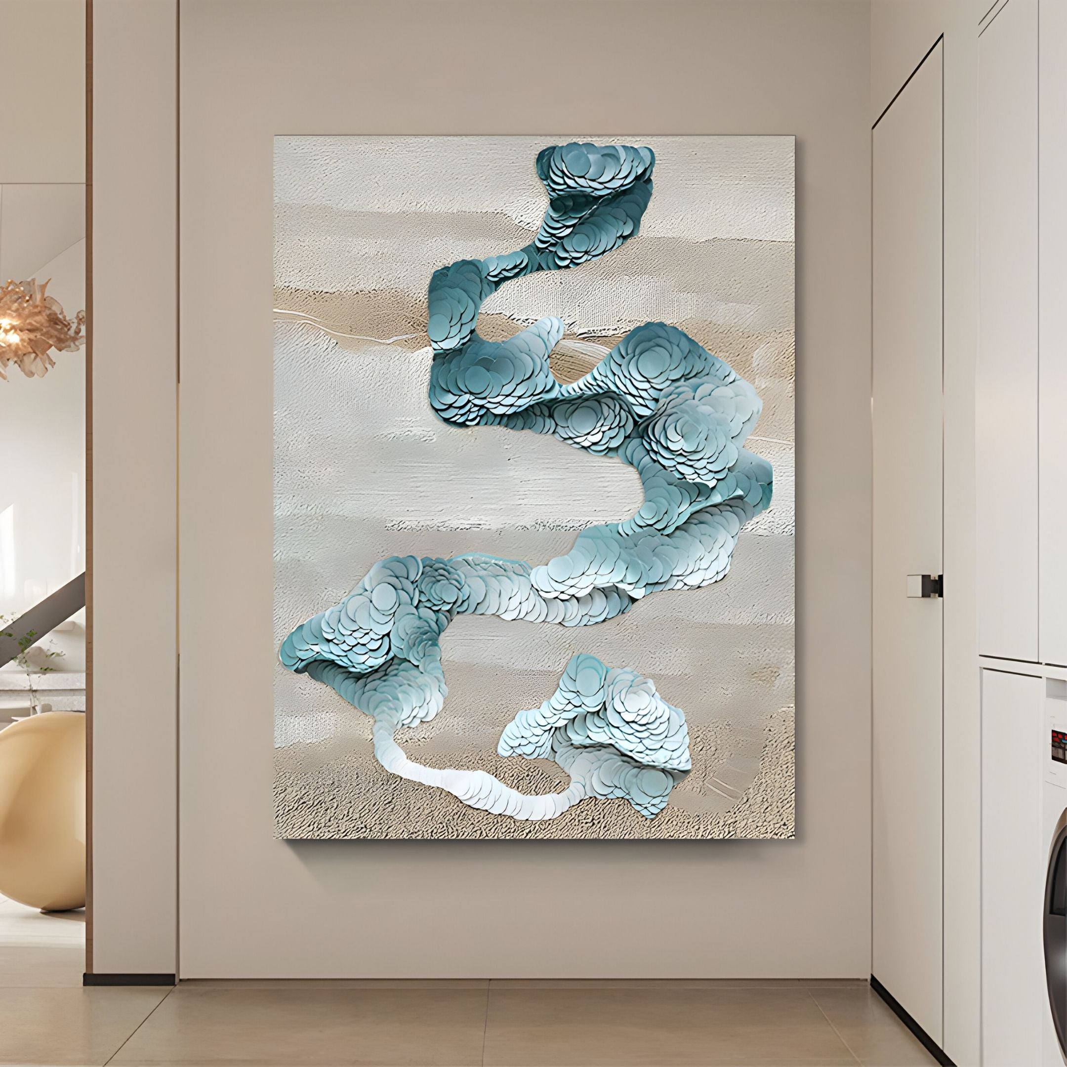 The Giant Sculptures Aqualoom II Layered Leather Hand-Painted 3D Wall Art, with swirling blue and white forms, hangs on a light wall in a modern, minimalistic room featuring neutral decor.