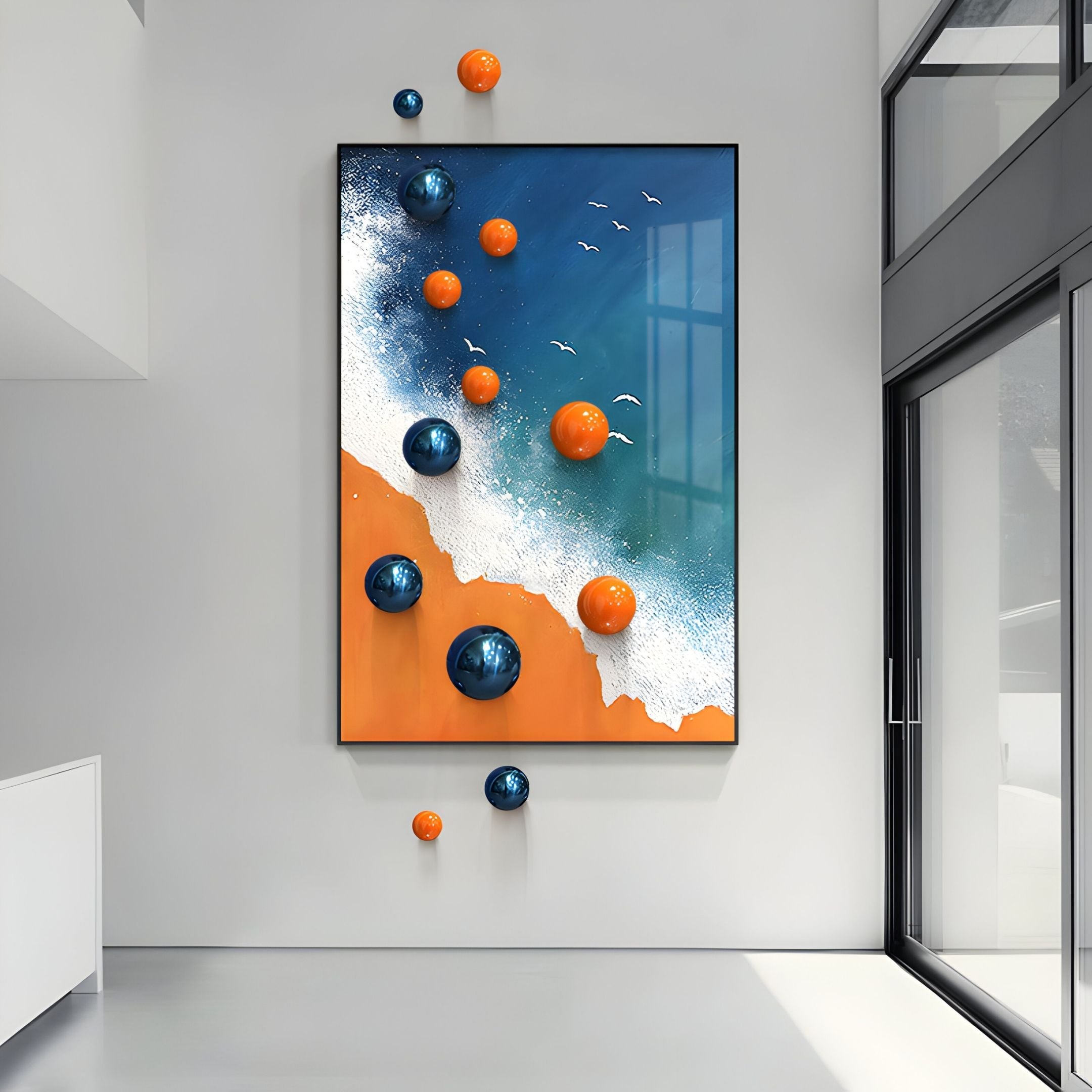 A modern hallway features Giant Sculptures' Tideborne Blue & Orange Coastal 3D Wall Art With Metal Balls, displaying beach-themed waves, seagulls, and large orange and blue metal spheres above an orange sandy shore.