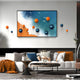 A modern living room features a white sofa with orange and blue accents, a round coffee table, and Giant Sculptures’ Tideborne Blue & Orange Coastal 3D Wall Art With Metal Balls, perfectly matching the vibrant décor.