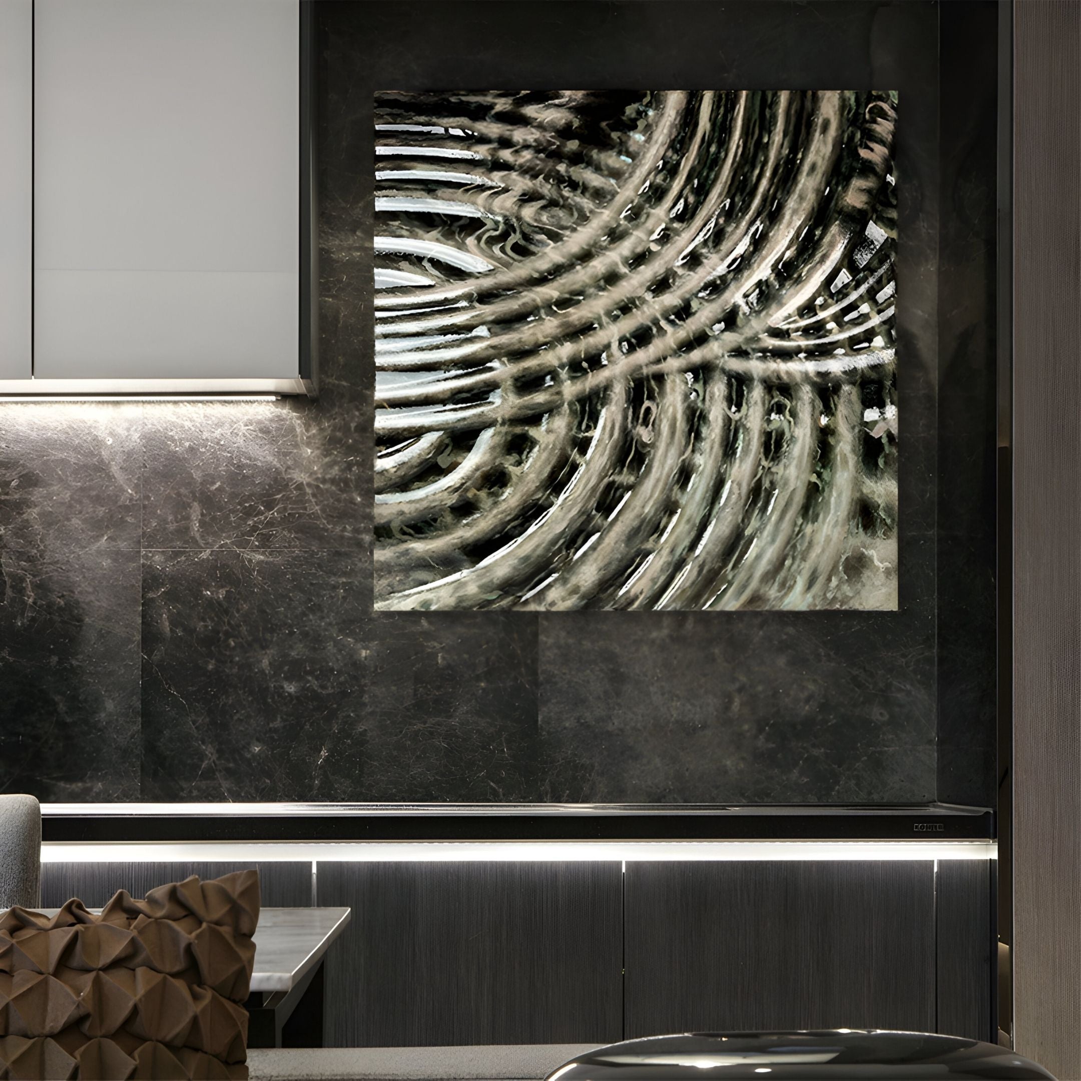 A modern kitchen with dark marble walls and cabinetry features Giant Sculptures’ Rillora Taupe & Graphite Ribbed Wood Carving 3D Wall Art. A geometric cushion is placed on a bench in the foreground.
