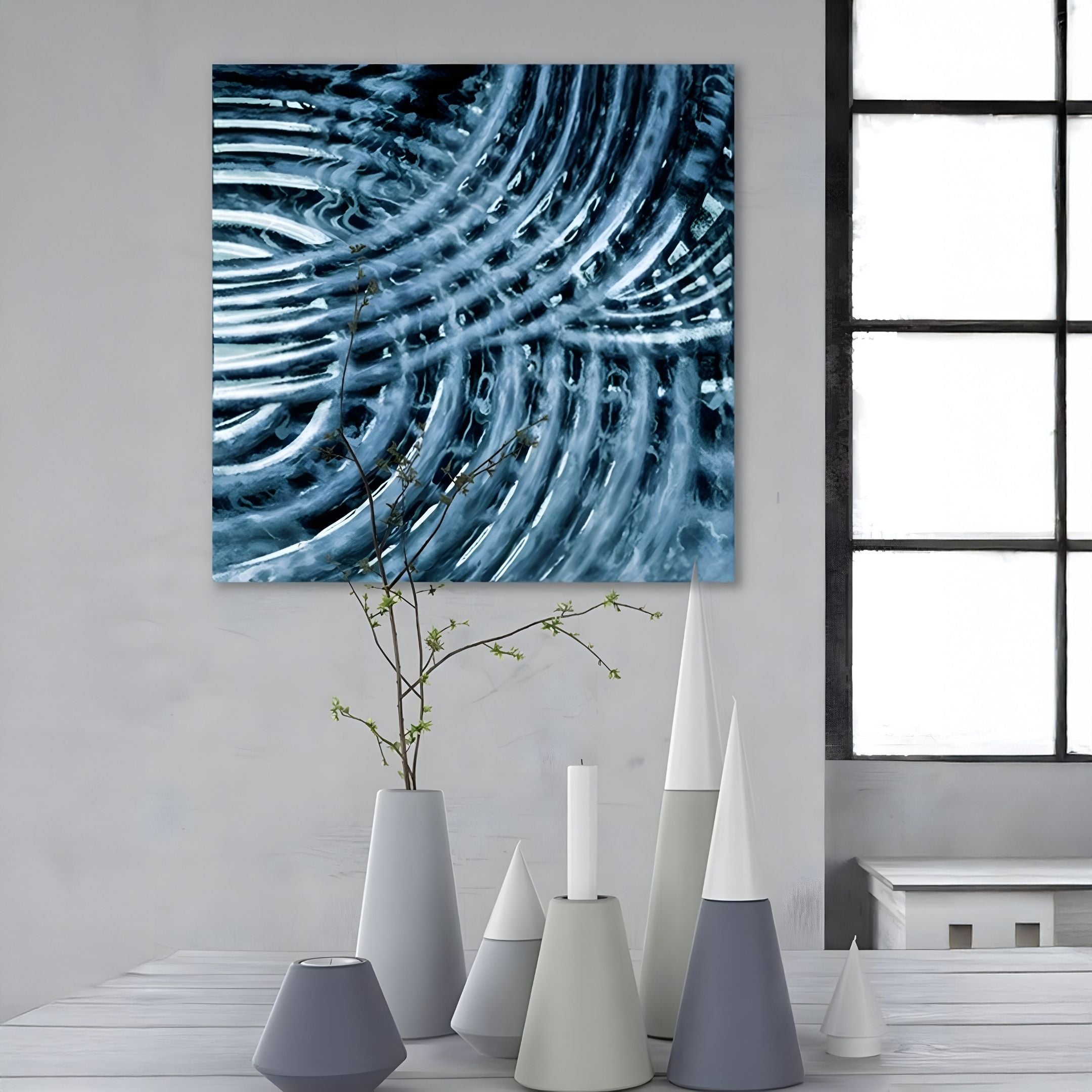 A modern dining area with geometric vases on a white table, a single branch in a vase, and the Rillora Blue Ribbed Wood Carving 3D Wall Art by Giant Sculptures beside a large window, highlighting stylish modern interior decor.