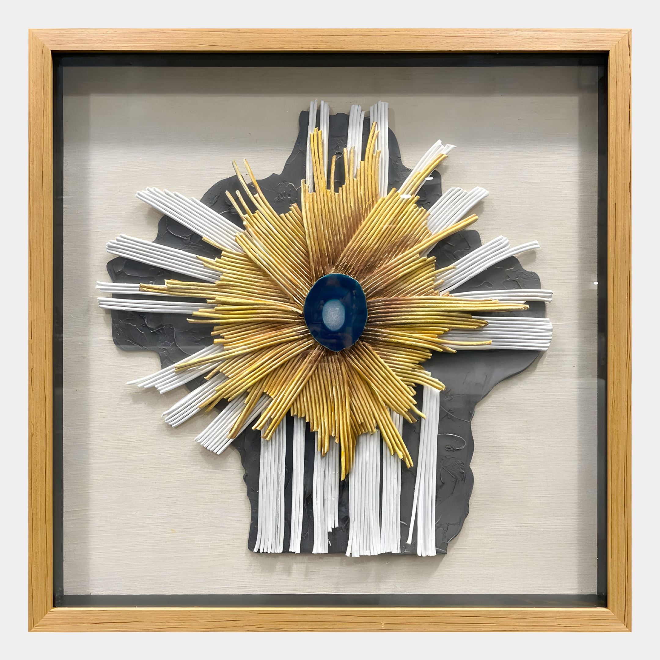 The Asterfold I White & Yellow Sunburst 3D Wall Art by Giant Sculptures features layered textures, a gray abstract base, gold and white radiating strips, and a glossy blue center—an eye-catching 3D piece for modern interiors.