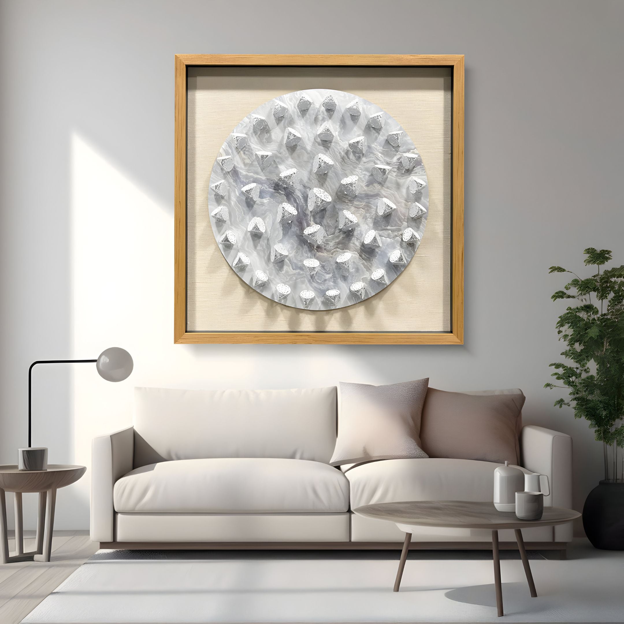 A modern living room featuring a light sofa, round coffee table, potted plant, and the Giant Sculptures Steelune Silver Metal Disc Spike 3D Wall Art above the couch for striking contemporary wall decor.