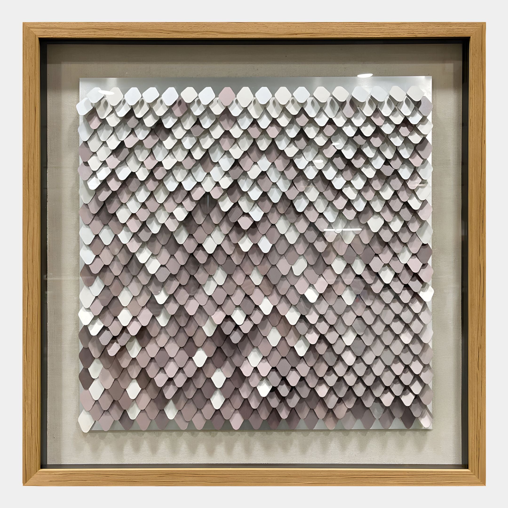 The Tessora White & Blush Scale Mosaic Metal 3D Wall Art by Giant Sculptures features overlapping diamond shapes in white, gray, and mauve, creating a textured scale-like pattern for modern decor.