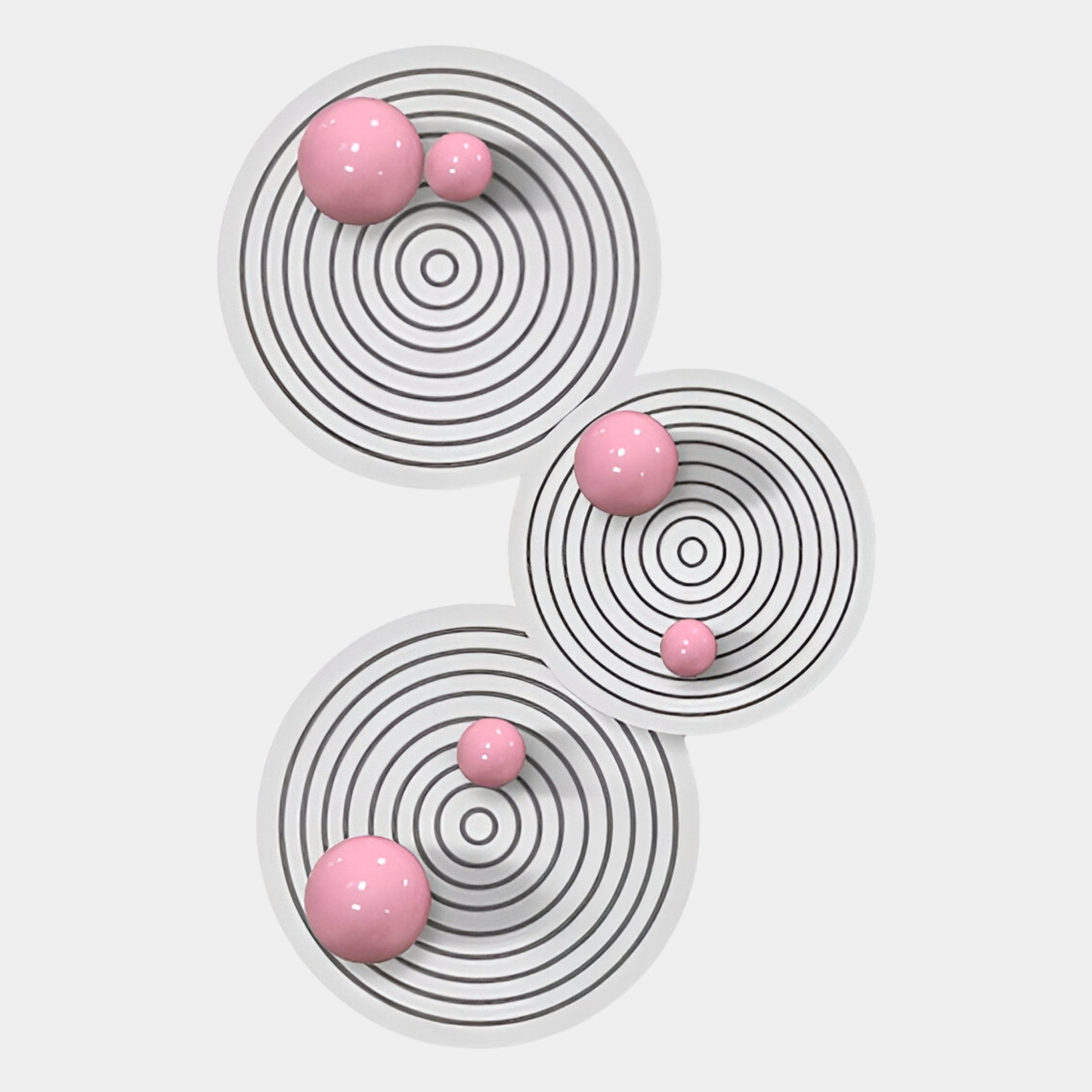 Giant Sculptures' Orbiora Pink Orb 3-Panel Concentric Sphere 3D Wall Art features three white panels with black concentric rings and glossy pink spheres, making a striking modern statement against a light background.