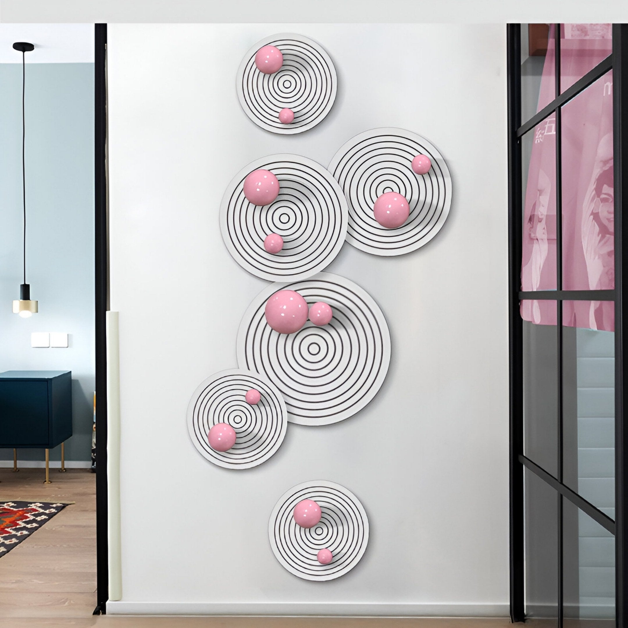 The Orbiora Pink Orb 5-Panel Concentric Sphere 3D Wall Art by Giant Sculptures features glossy pink orbs and black concentric rings, creating a bold modern focal point for any contemporary white wall.
