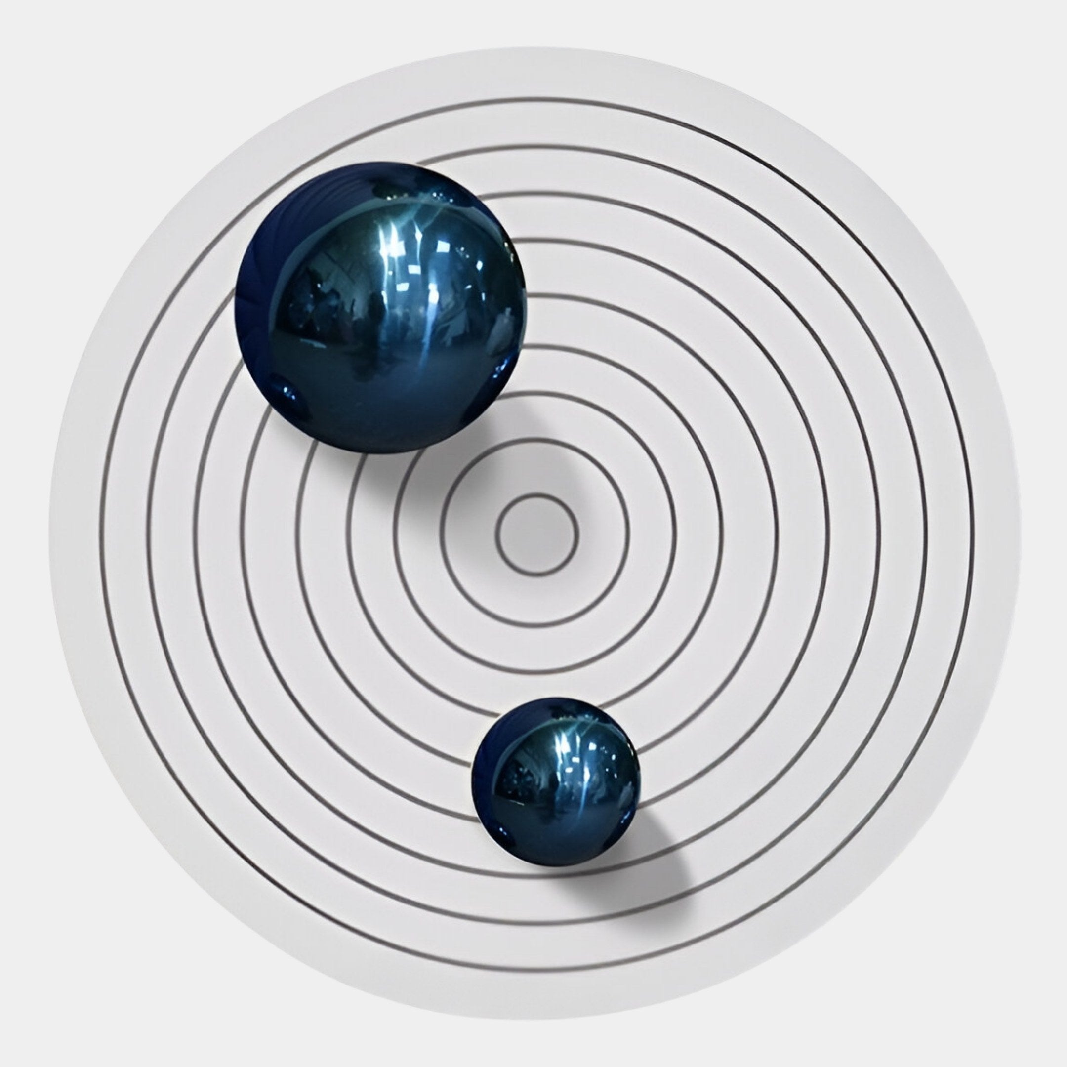 The Orbiora IV Blue Duo Concentric Sphere 3D Wall Art by Giant Sculptures features two reflective blue spheres on a white surface with black concentric circles—ideal for bold, contemporary wall decor or unique 3D art displays.