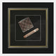 The Havantra Cigar & Checked Case Framed Wall Art by Giant Sculptures showcases a checkered wallet and cigar on a black matte background, beautifully enclosed in an ornate, silver-trimmed frame—perfect masculine decor.