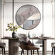 A modern dining room showcases the Erosian Rose Textured Round Mirror 3D Wall Art by Giant Sculptures above a dark wooden table set for dining, with decorative flowers and stylish chairs completing the elegant, contemporary look.