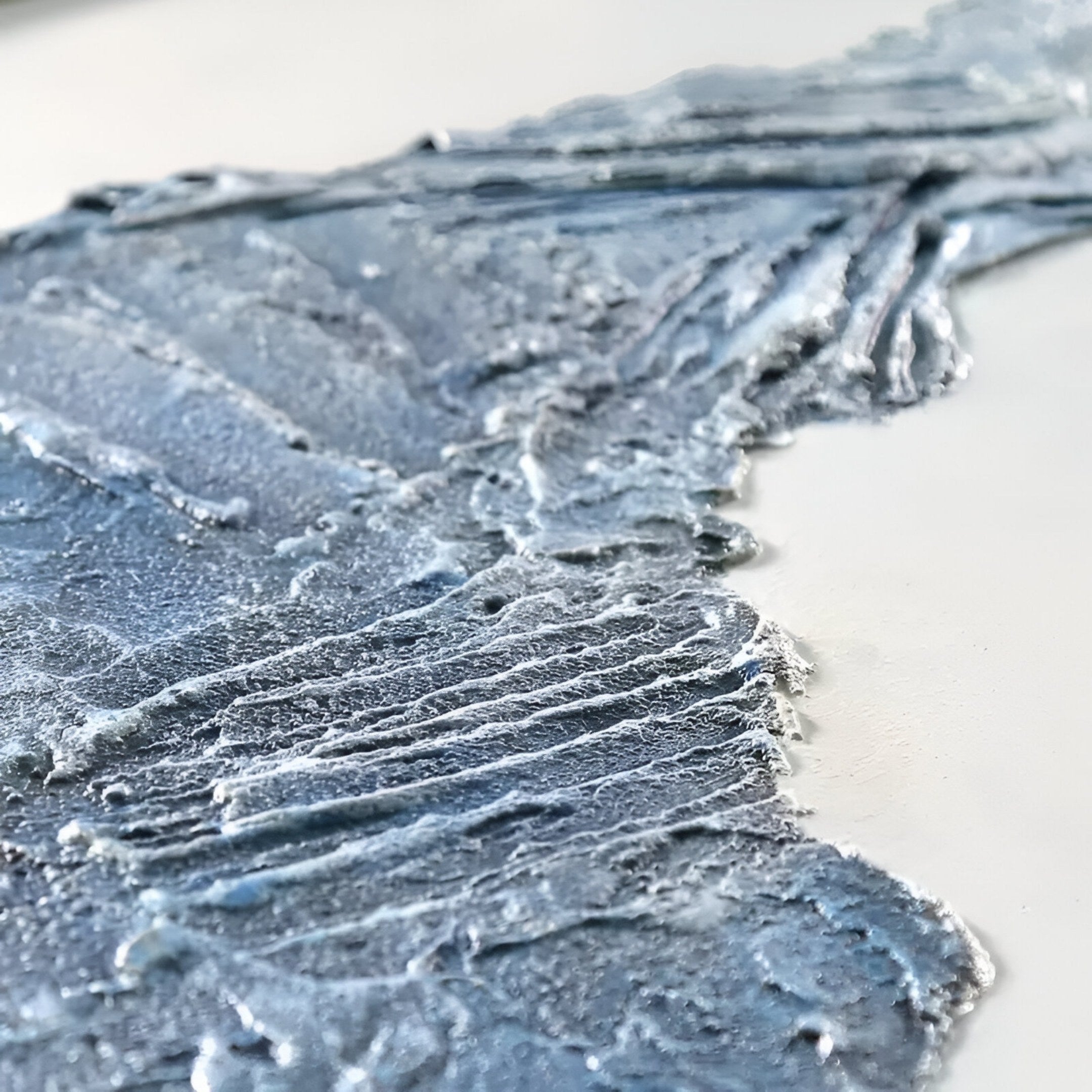 The Cryora Blue Flow Textured Round 3D Wall Art by Giant Sculptures features bold blue and white textures with thick, layered brushstrokes—ideal as contemporary decor or blue flow art for modern interiors.