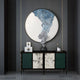 A modern console table with green and white bamboo-patterned doors stands against a dark wall, topped with decor and a large Cryora Blue Flow Textured Round 3D Wall Art by Giant Sculptures featuring abstract textures.