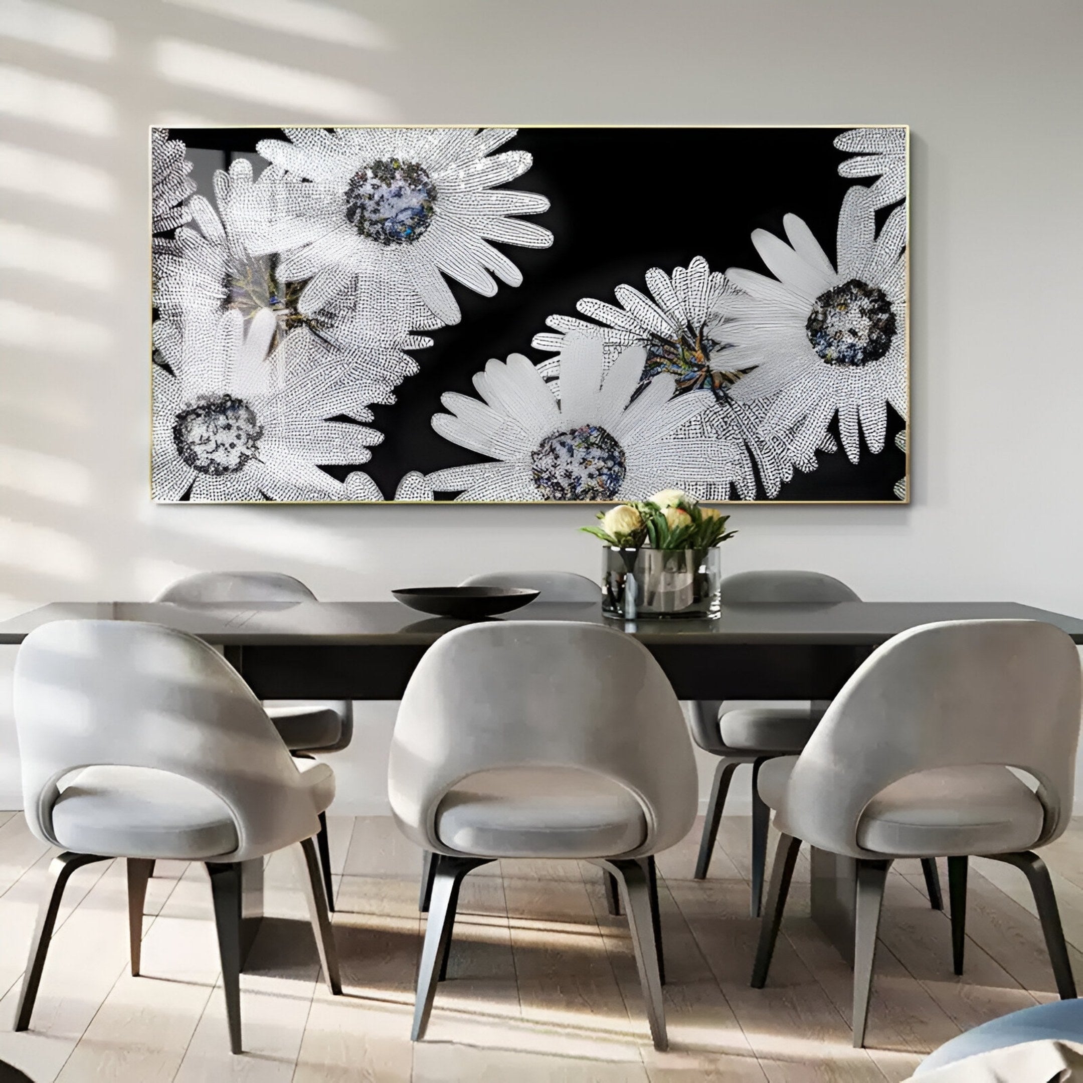 A modern dining room with six light gray chairs around a dark table features Giant Sculptures' Floravida Pure White Crystal Daisy Floral 3D Wall Art. A vase of flowers adds to the contemporary style.