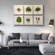 A modern living room features a light gray sofa with black and white cushions, black tables, and the Florvara Botanical Leaves 6-Panel Acrylic 3D Wall Art by Giant Sculptures. A floor lamp beside the sofa completes the Nordic minimal look.
