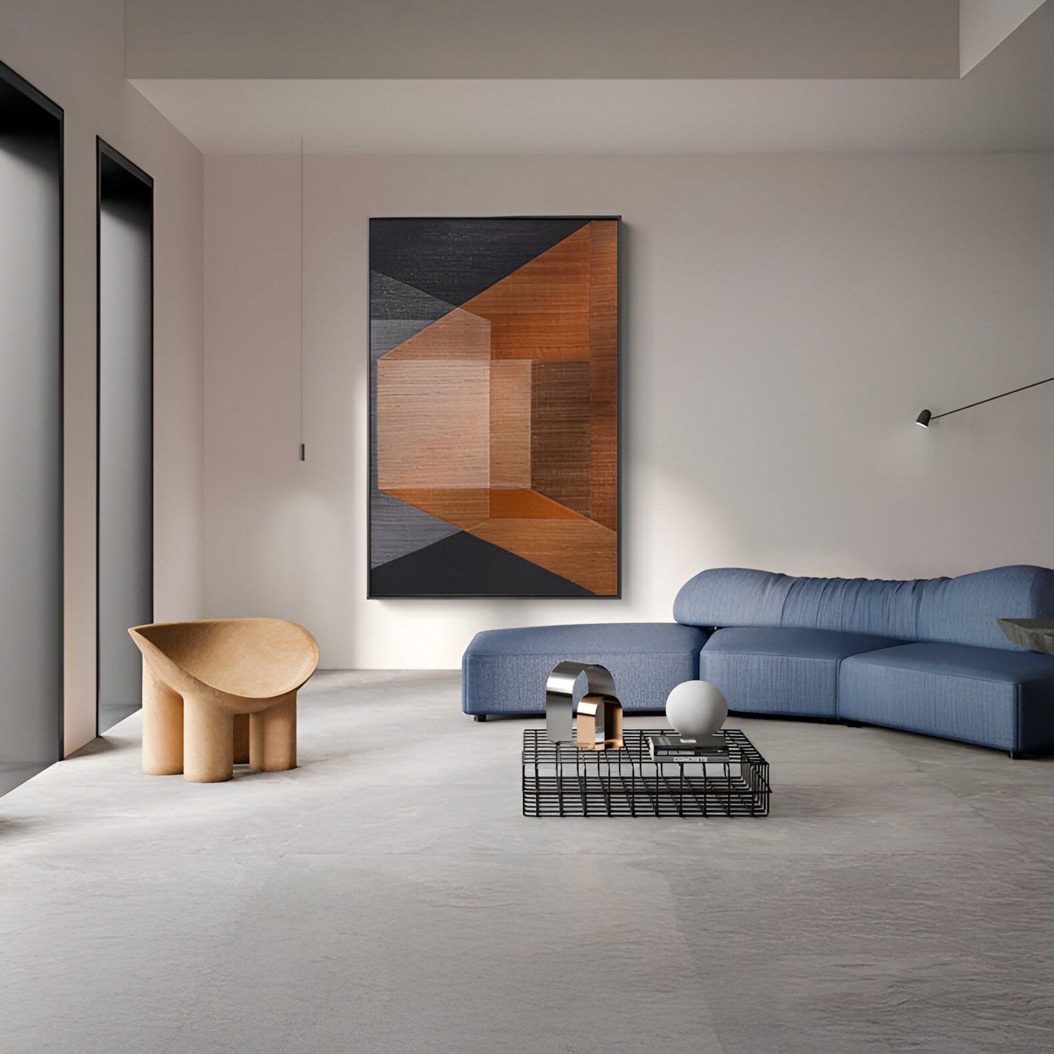 A modern living room with a blue sectional sofa, a sculptural beige chair, a black wire coffee table with decor, and Striatura Rust & Grey Rope Abstract 3D Wall Art by Giant Sculptures. Large windows fill the space with natural light.