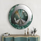 The Portara Green Bridge Illusion Round 3D Wall Art by Giant Sculptures features green and silver accents, reflecting a symmetrical hallway above a console table with books, brass giraffe figurines, and floral vases.