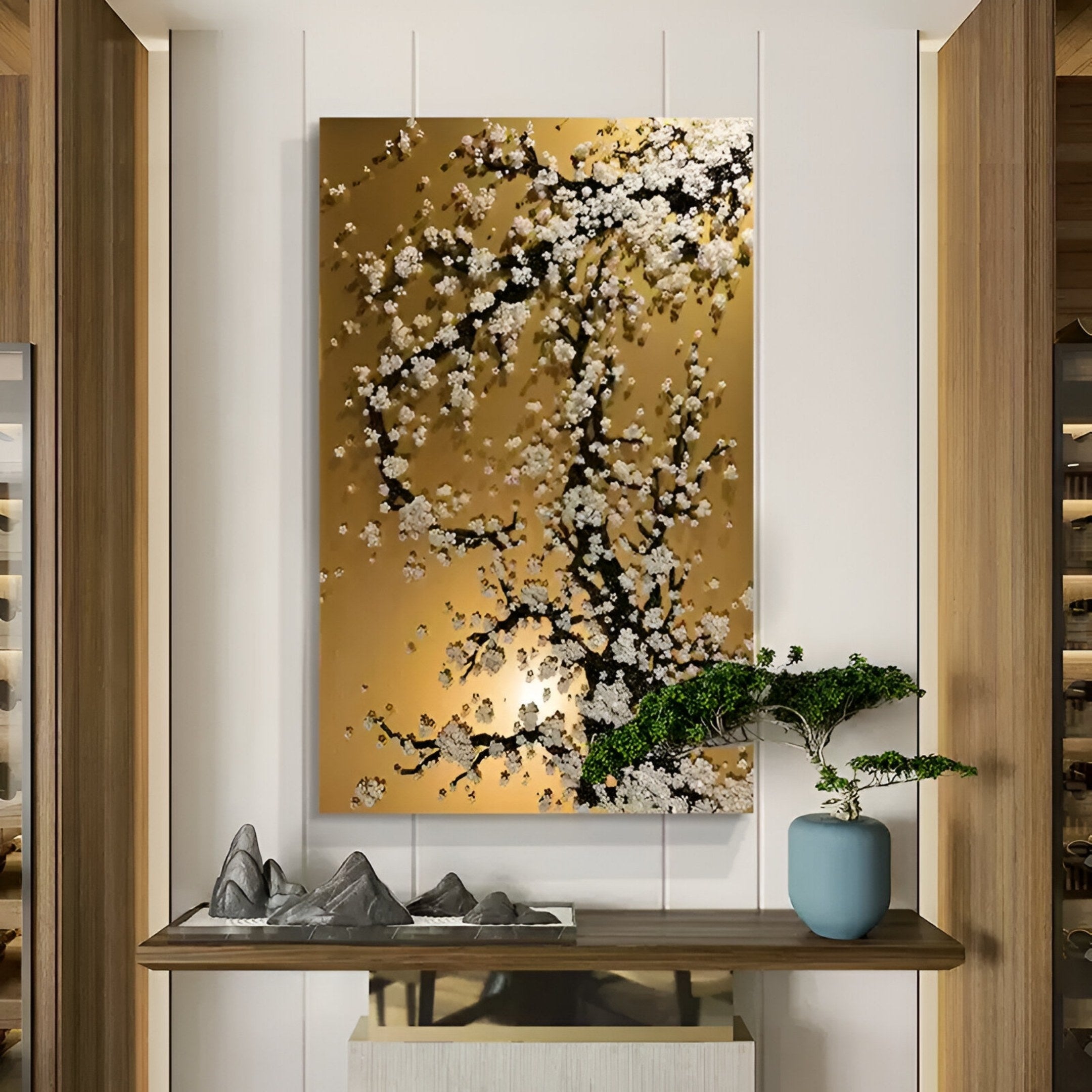 A modern interior showcases the Florivine Gold Blossom Tree Button 3D Wall Art by Giant Sculptures in gold and black above a wooden console table, which holds a blue bonsai vase and a decorative stone sculpture.