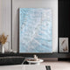 A modern living room featuring the Aqualis Blue Ripple Textured Abstract Acrylic 3D Wall Art by Giant Sculptures, complemented by minimalist furniture, dried floral arrangements, and neutral-toned decor.