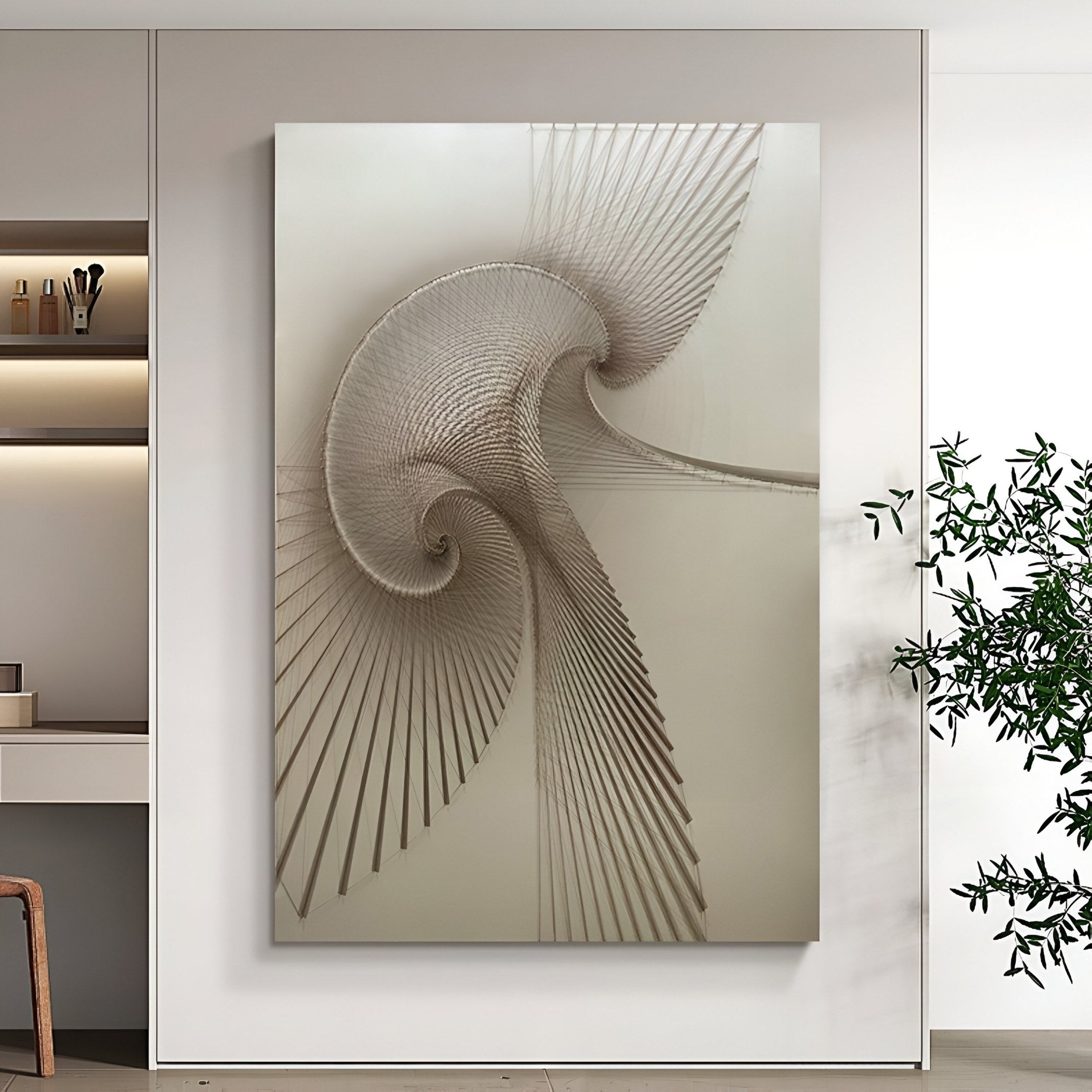 The Spiralis Natural String Abstract Lines Swirl 3D Wall Art by Giant Sculptures hangs on a modern white wall. A plant is on the right; shelves with decor to the left give the minimal, contemporary space a stylish touch.