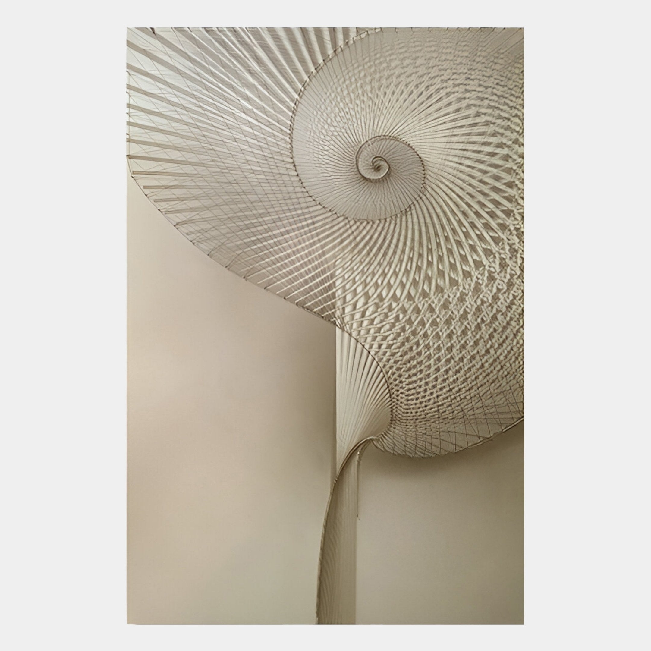 The Spiralis Natural String Abstract Lines Spiral 3D Wall Art by Giant Sculptures features an elegant, fan-like woven pattern, curving seamlessly from wall to ceiling as a striking metallic abstract accent in a beige room.